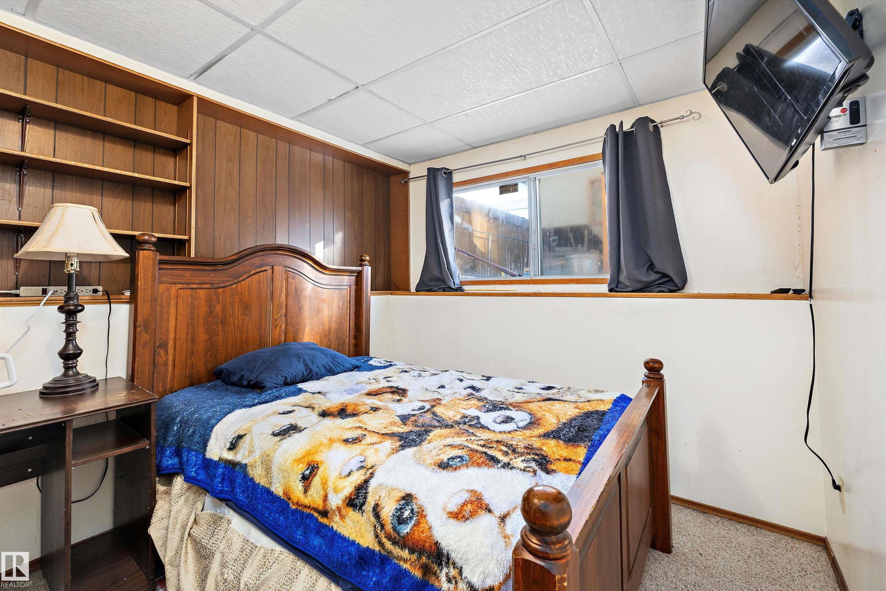 Bedroom featuring a drop ceiling and wooden walls - 12117 91 Street, Edmonton, AB - Indoor Photo Showing Bedroom