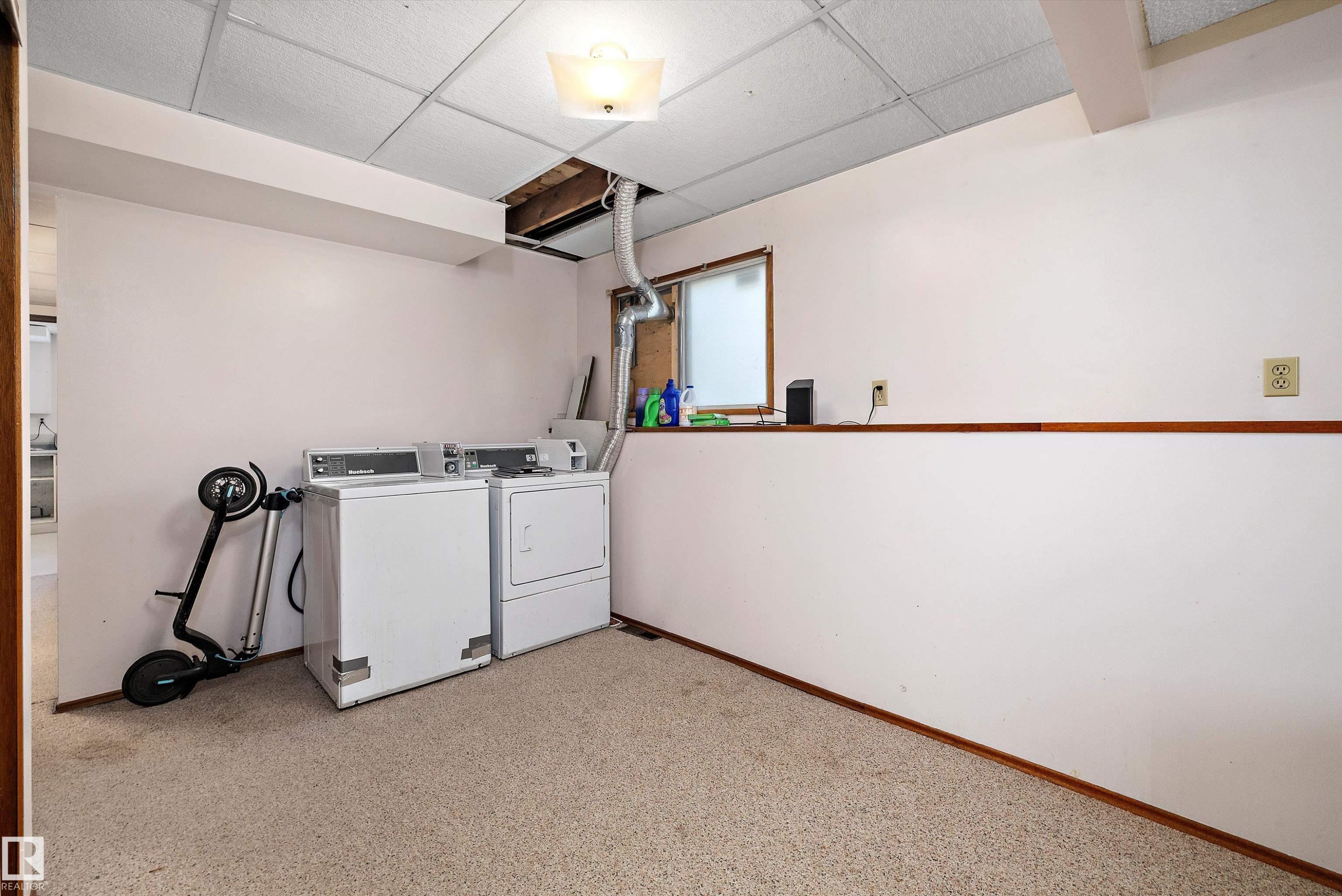 Communal laundry room with a paneled ceiling and separate washer and dryer - 12117 91 Street, Edmonton, AB - Indoor Photo Showing Laundry Room