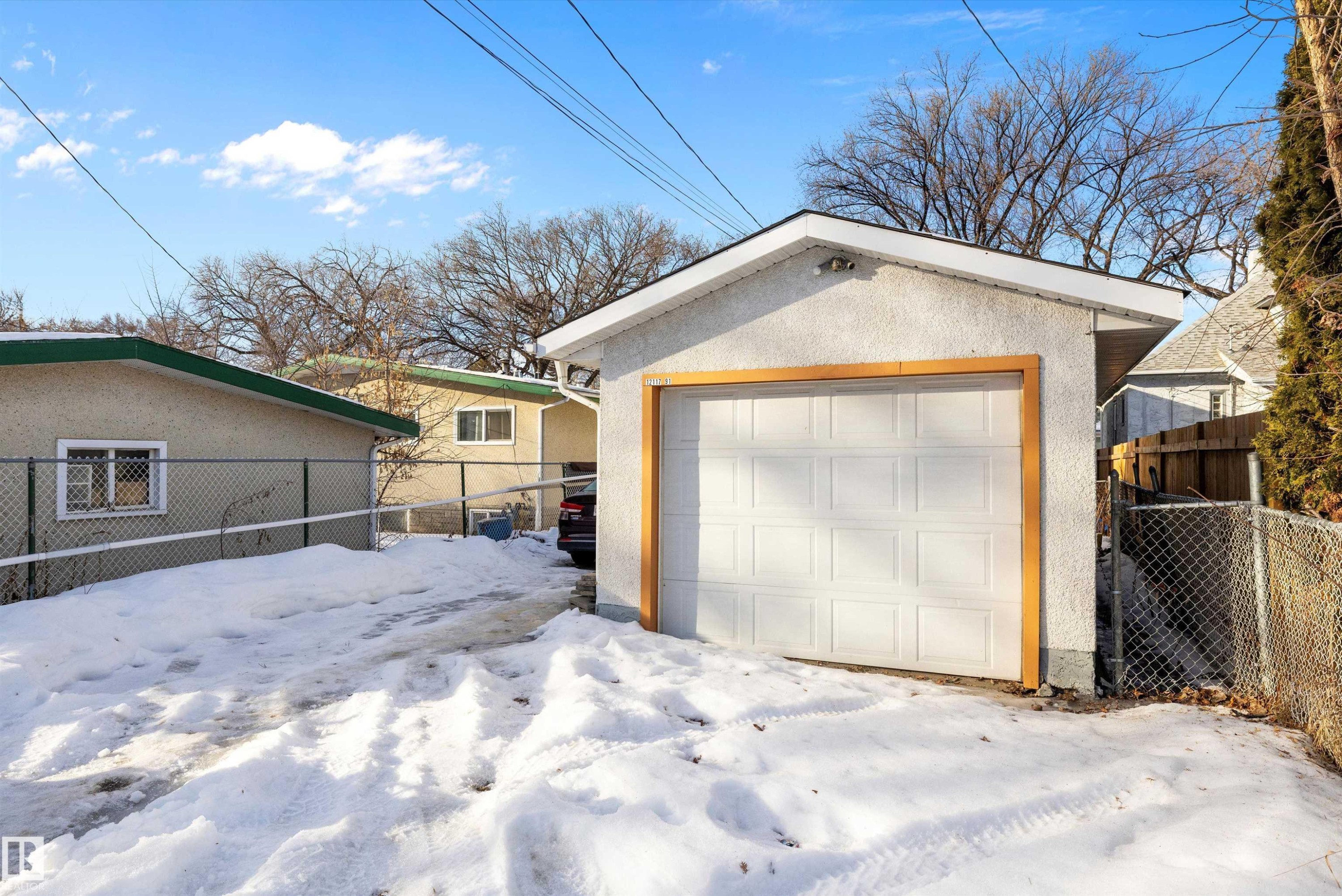 Snow covered garage with a garage - 12117 91 Street, Edmonton, AB - Outdoor With Exterior