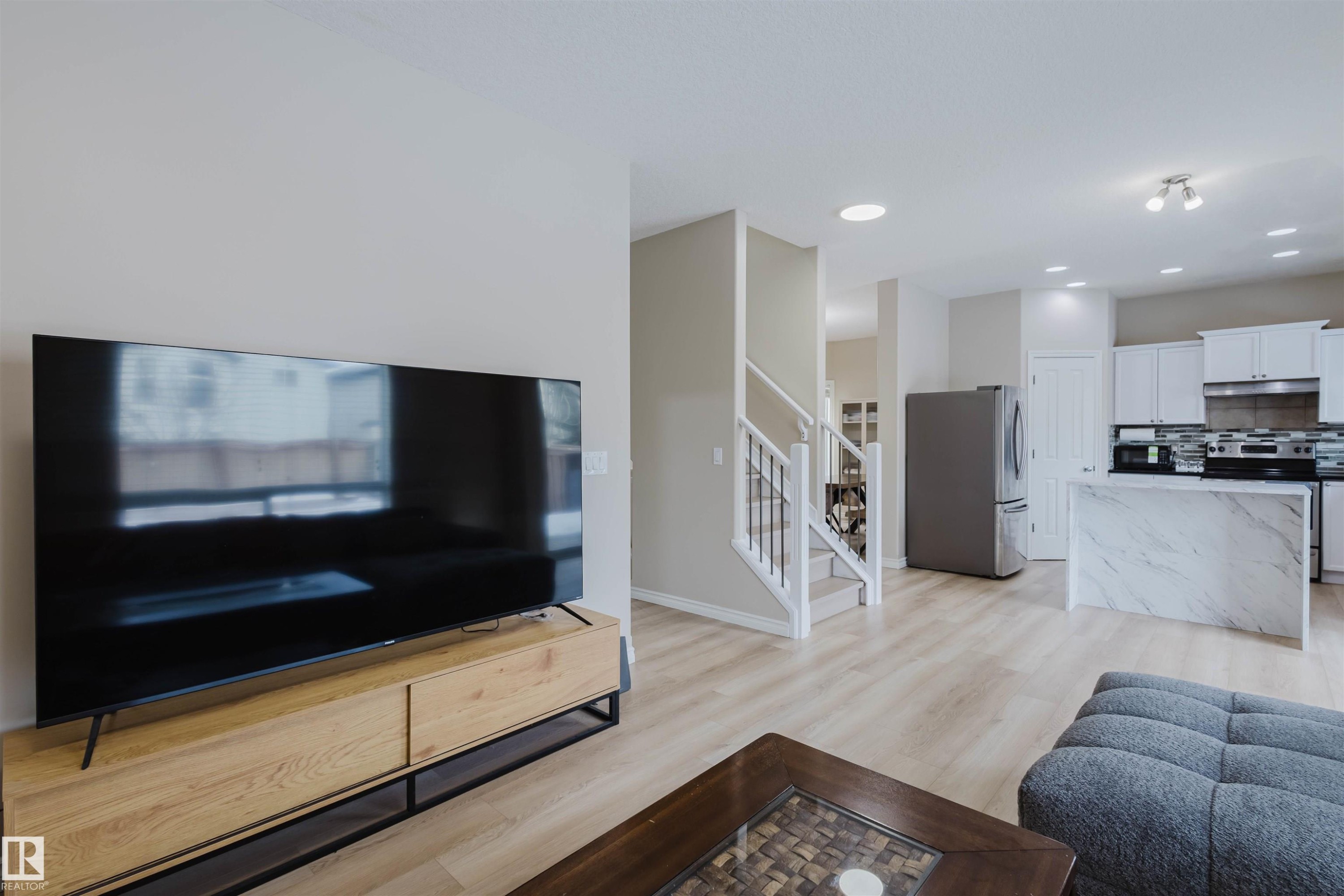 Living area featuring light wood-style flooring and recessed lighting - 8420 Sloane Crescent, Edmonton, AB - Indoor