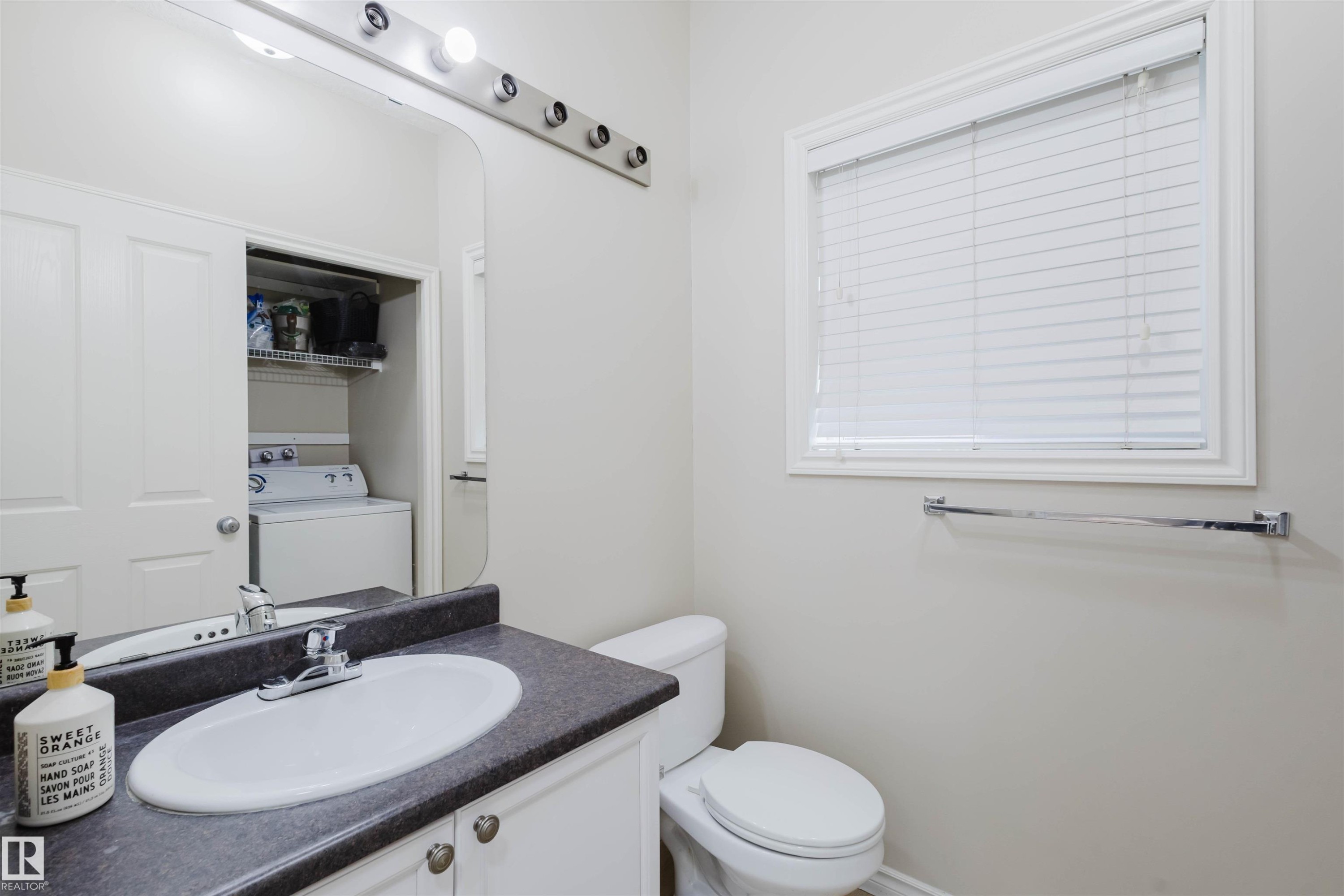 Half bathroom with vanity and washer / clothes dryer - 8420 Sloane Crescent, Edmonton, AB - Indoor Photo Showing Bathroom