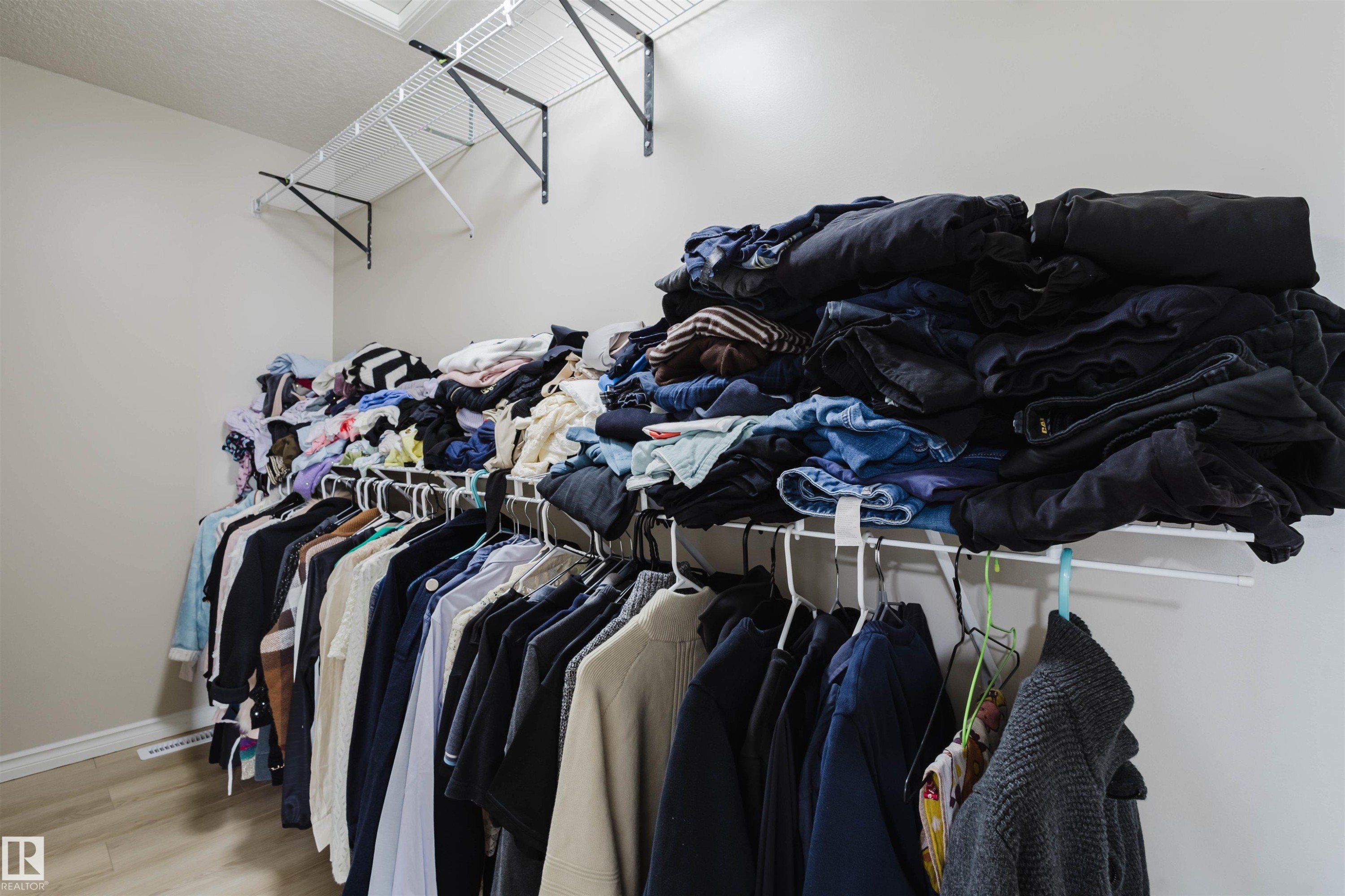 Walk in closet featuring wood finished floors - 8420 Sloane Crescent, Edmonton, AB - Indoor With Storage