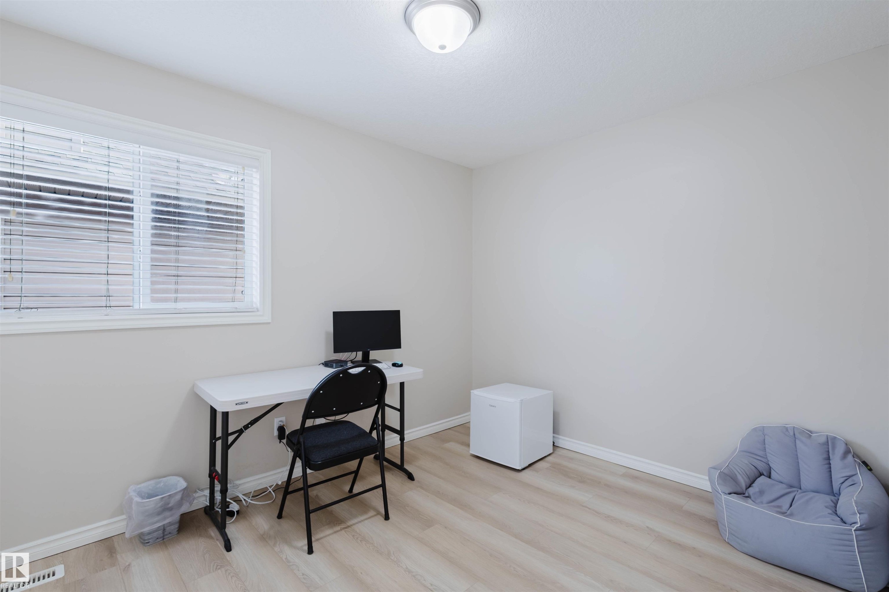 Home office featuring baseboards and wood finished floors - 8420 Sloane Crescent, Edmonton, AB - Indoor Photo Showing Office