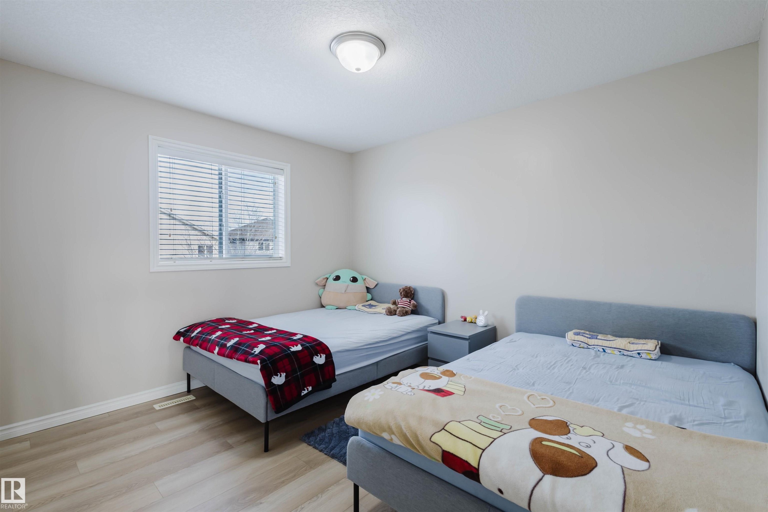 Bedroom featuring light wood-style floors and baseboards - 8420 Sloane Crescent, Edmonton, AB - Indoor Photo Showing Bedroom
