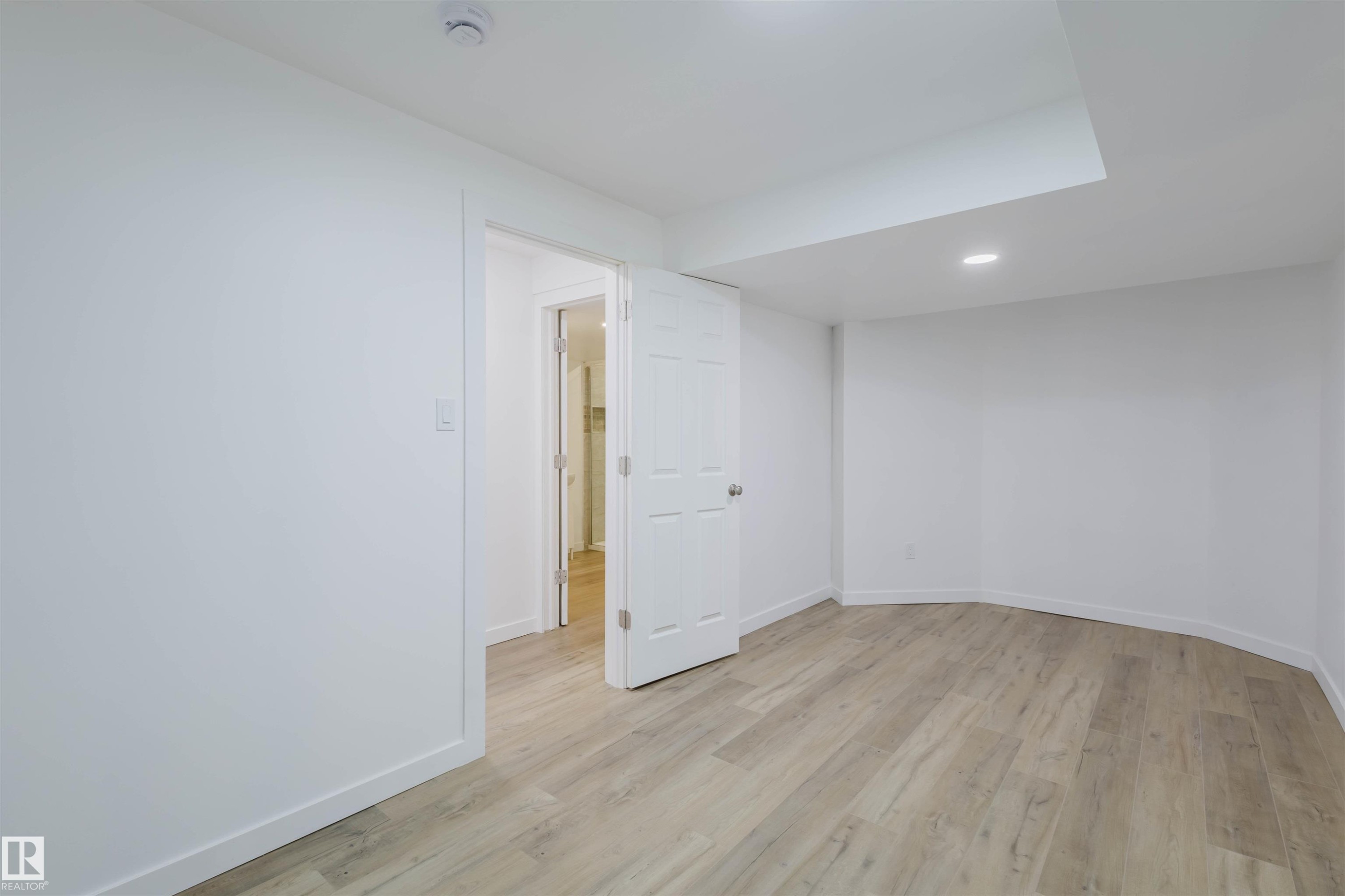 Spare room with light wood-style floors and recessed lighting - 8420 Sloane Crescent, Edmonton, AB - Indoor Photo Showing Other Room