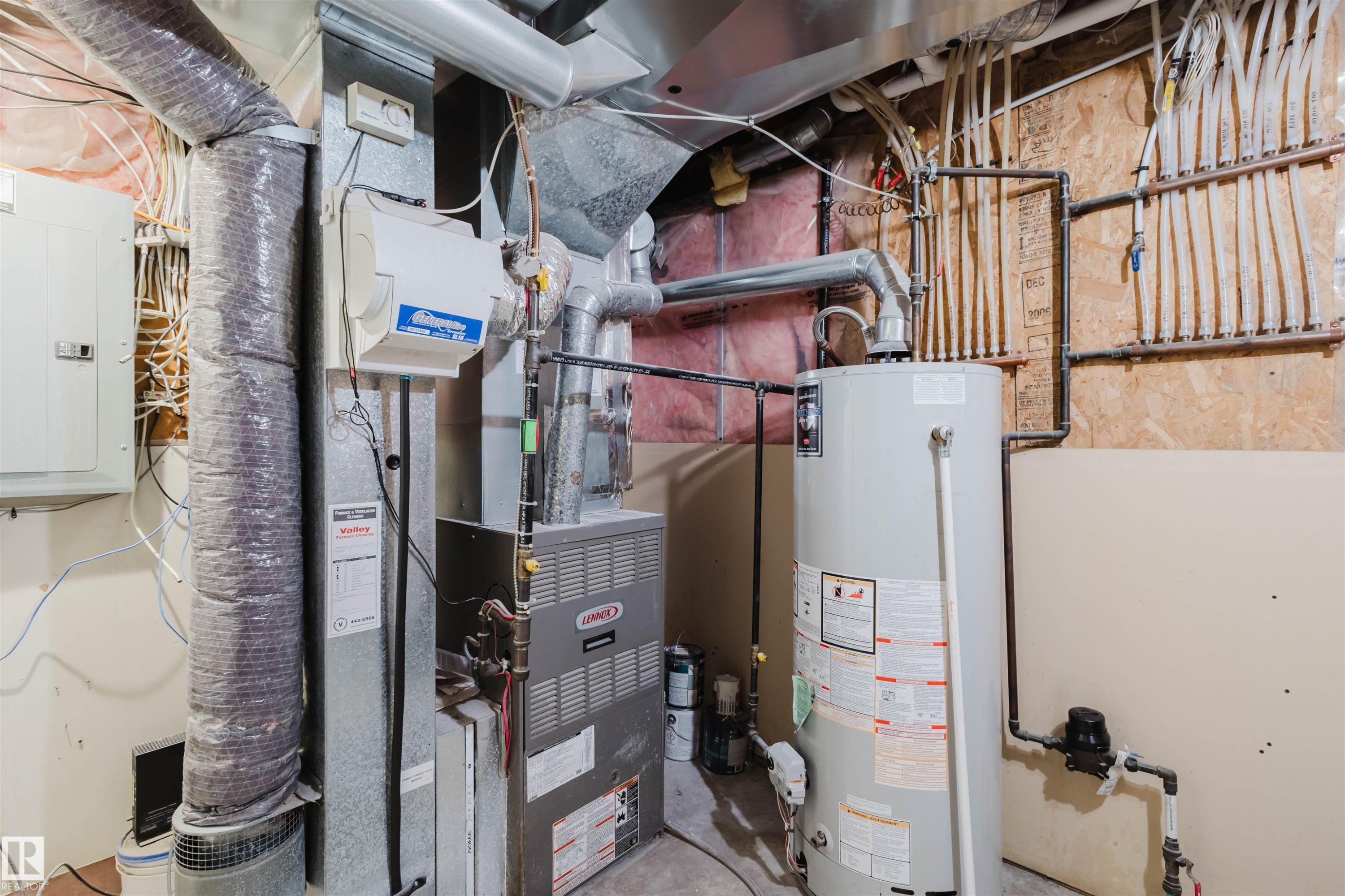 Utilities featuring electric panel, heating unit, and gas water heater - 8420 Sloane Crescent, Edmonton, AB - Indoor Photo Showing Basement