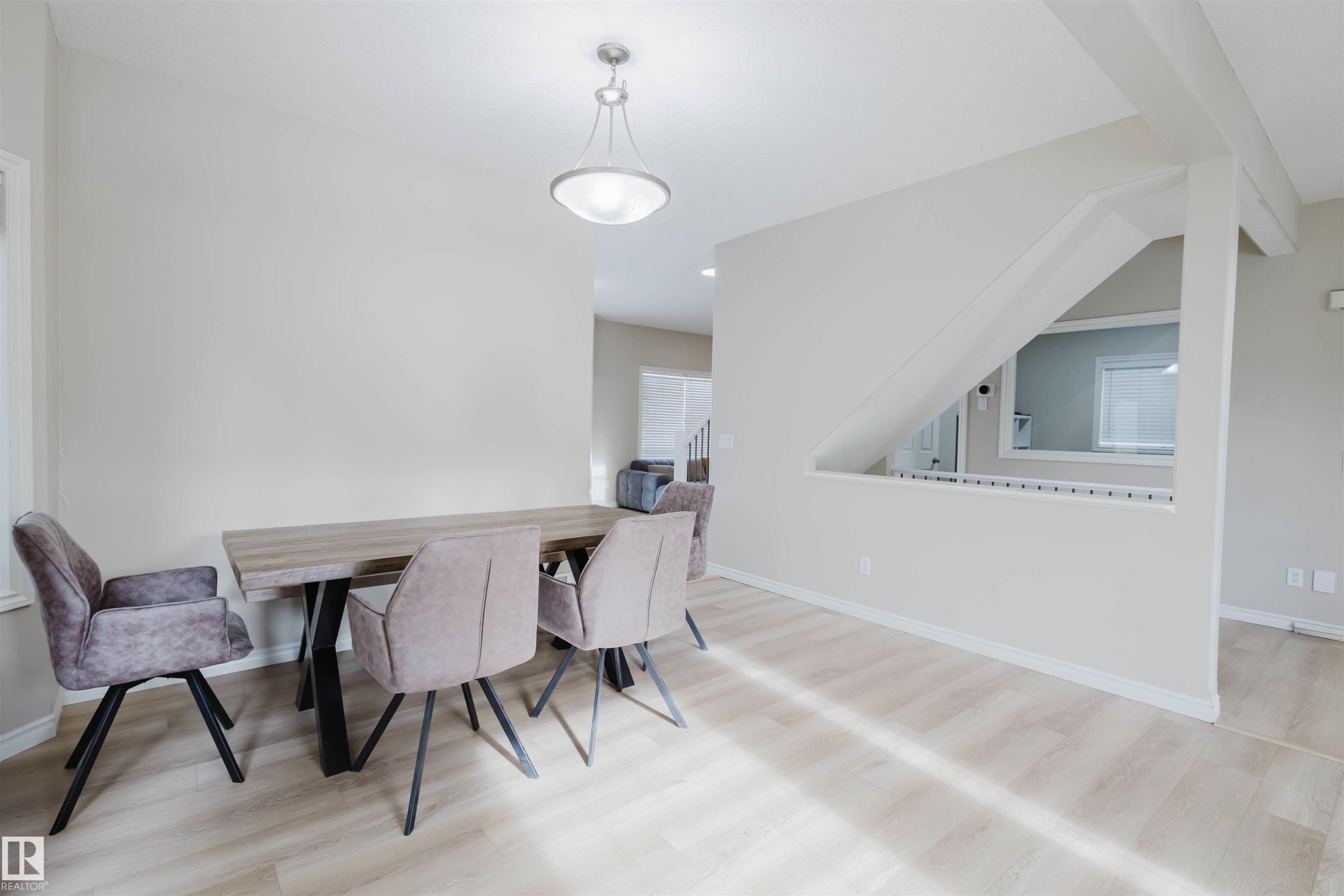 Dining space with light wood finished floors and baseboards - 8420 Sloane Crescent, Edmonton, AB - Indoor Photo Showing Dining Room