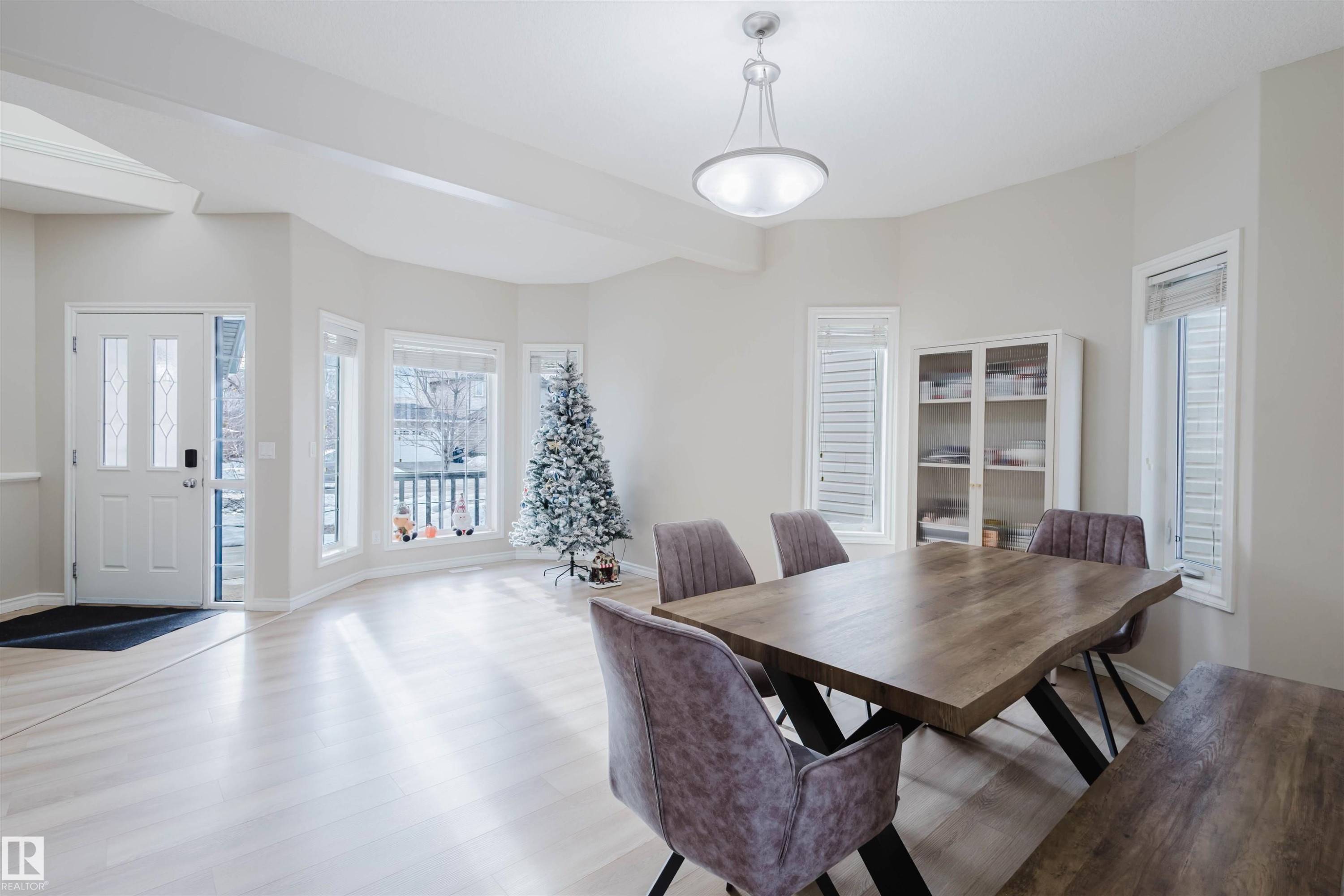 Dining space with light wood finished floors and beam ceiling - 8420 Sloane Crescent, Edmonton, AB - Indoor Photo Showing Dining Room