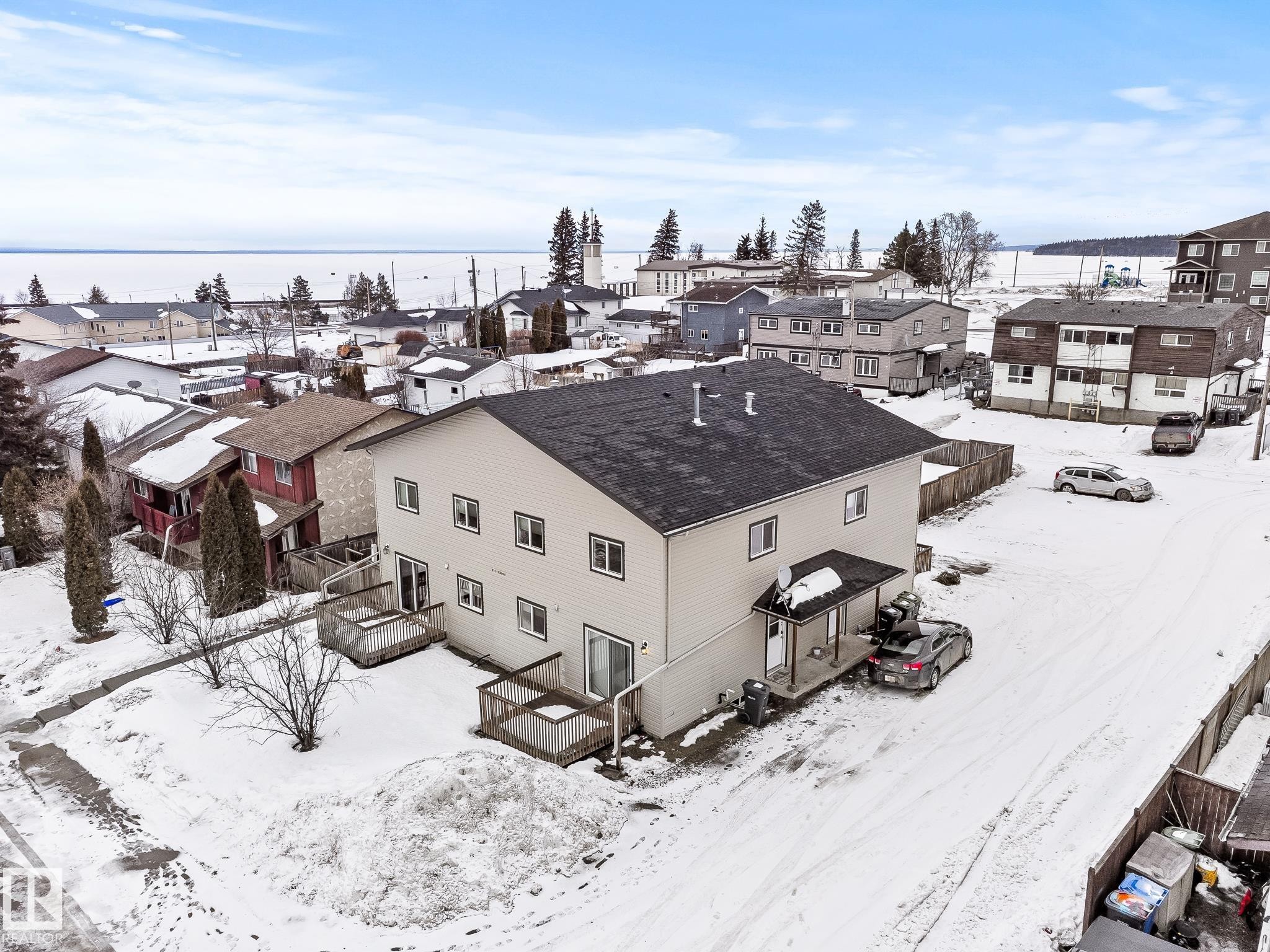 Snowy aerial view with a residential view - 914 9 Street, Cold Lake, AB - Outdoor With Body Of Water
