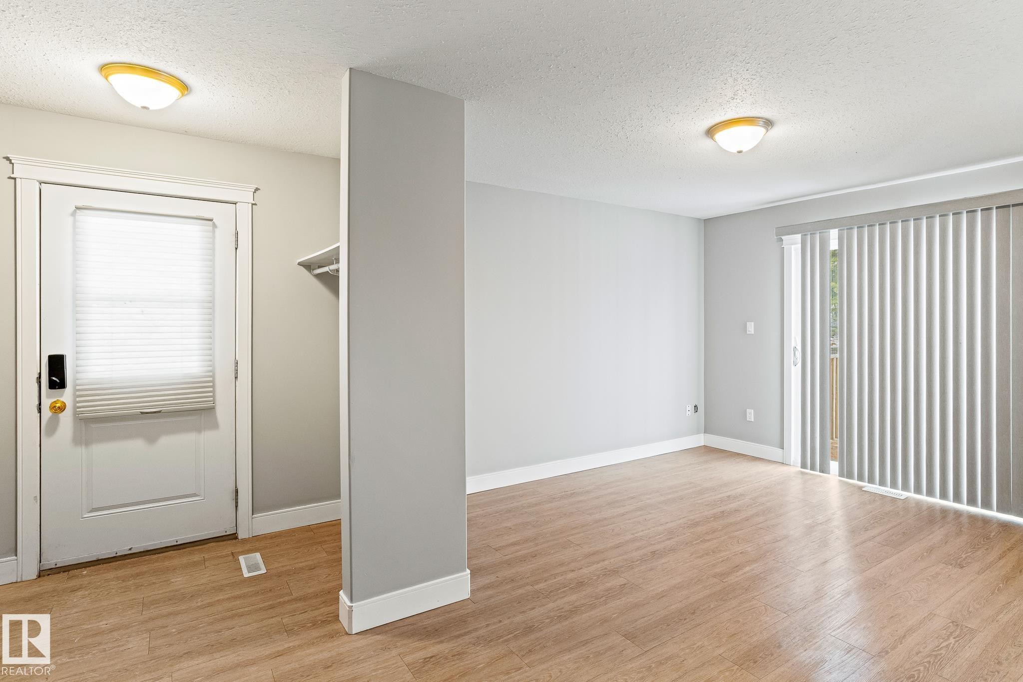 Unfurnished room with a textured ceiling and light wood-type flooring - 914 9 Street, Cold Lake, AB - Indoor Photo Showing Other Room