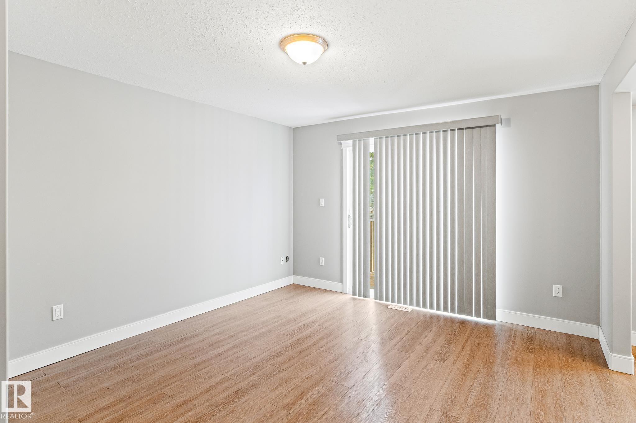 Unfurnished room featuring light wood-style flooring and a textured ceiling - 914 9 Street, Cold Lake, AB - Indoor Photo Showing Other Room