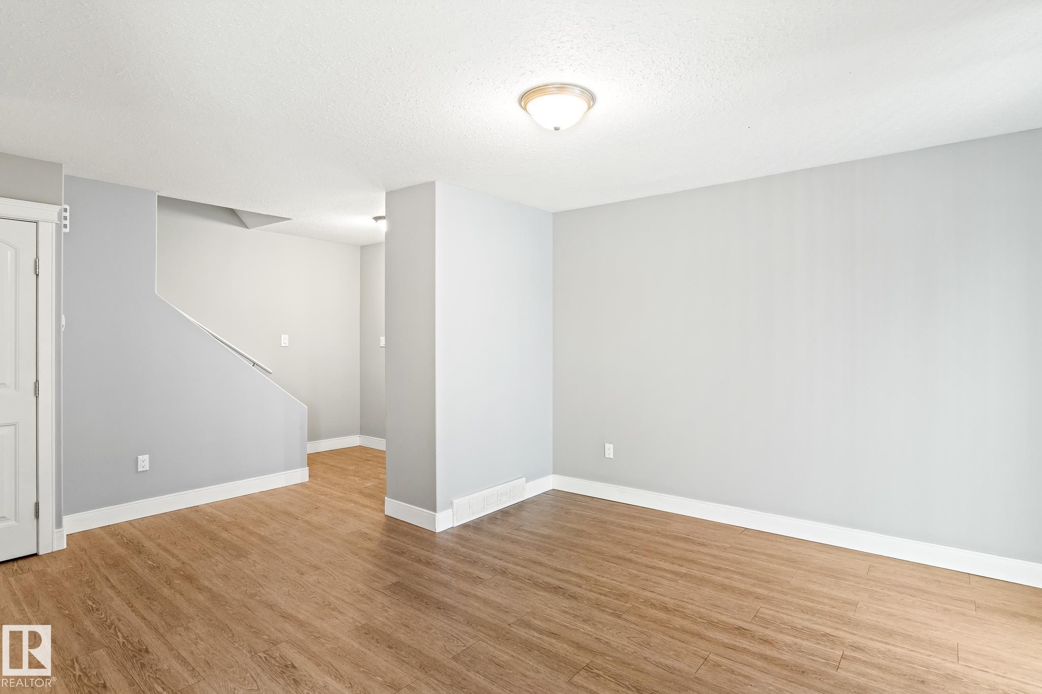 Living room featuring light wood finished floors and a textured ceiling - 914 9 Street, Cold Lake, AB - Indoor Photo Showing Other Room