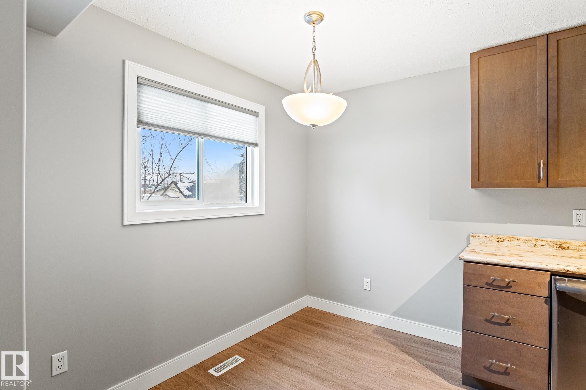 Unfurnished dining area featuring baseboards and light wood finished floors - 914 9 Street, Cold Lake, AB - Indoor