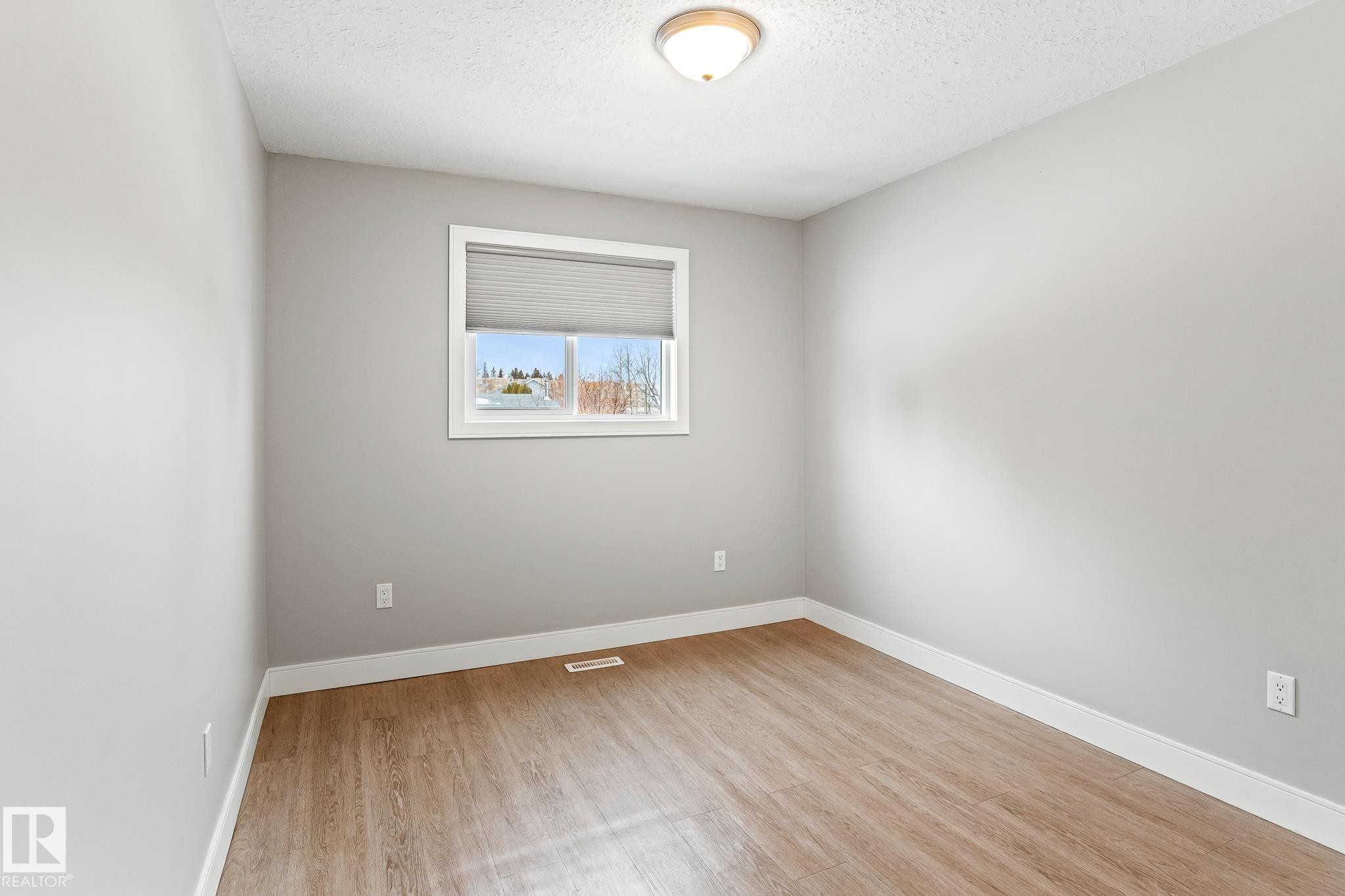 Bedroom with light wood-style floors and a textured ceiling - 914 9 Street, Cold Lake, AB - Indoor Photo Showing Other Room
