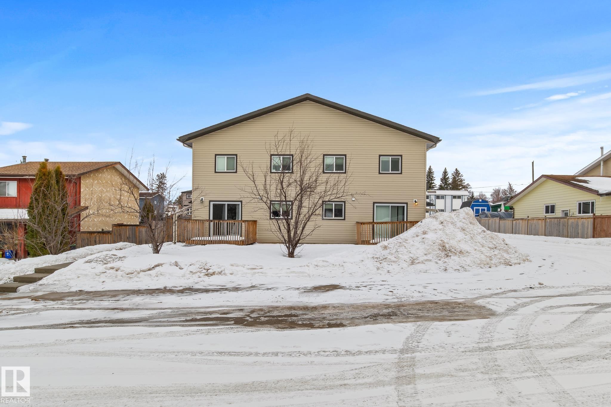 Snow covered back of property with a wooden deck - 914 9 Street, Cold Lake, AB - Outdoor