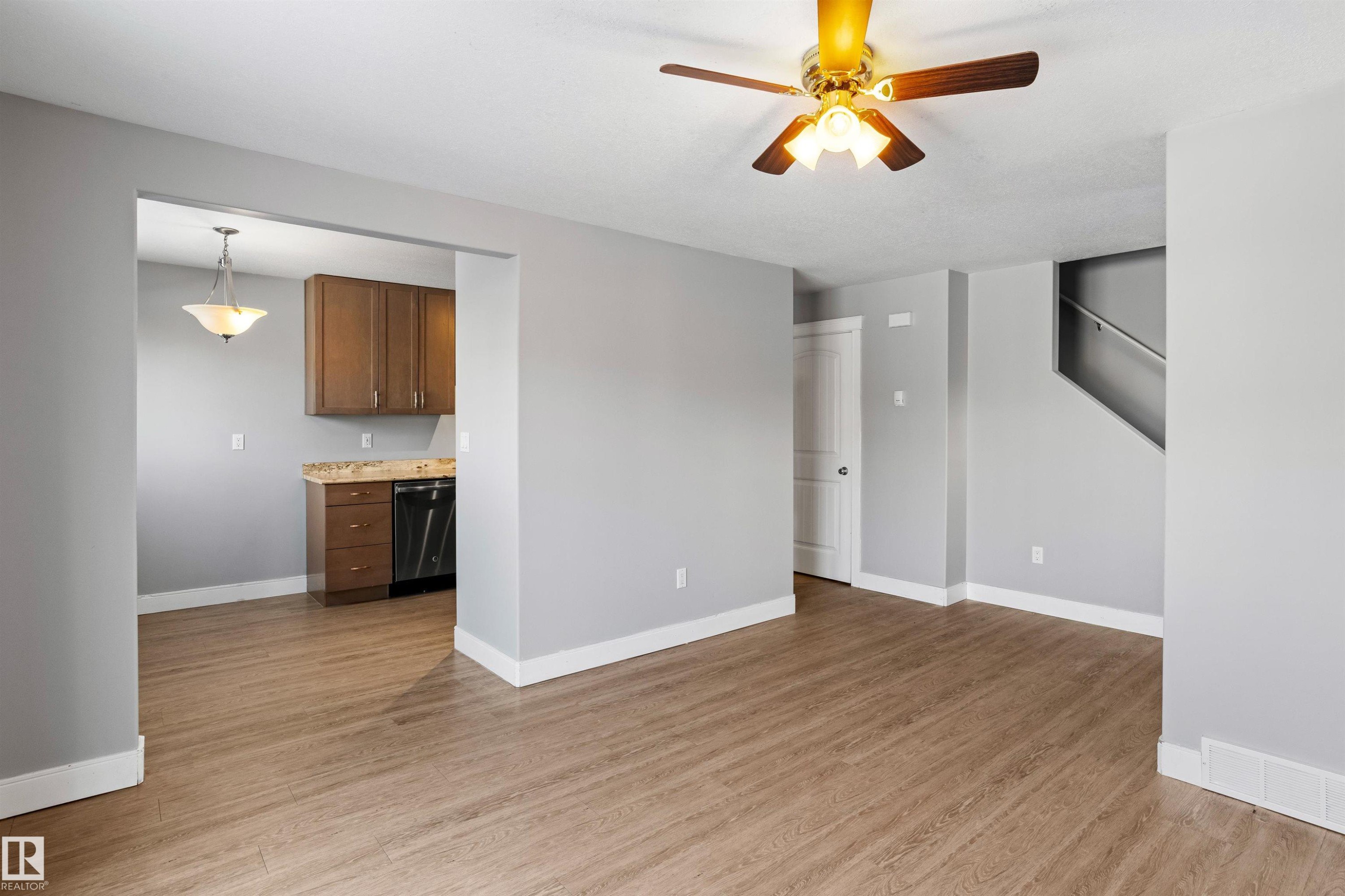 Unfurnished living room featuring light wood-style floors and a ceiling fan - 914 9 Street, Cold Lake, AB - Indoor