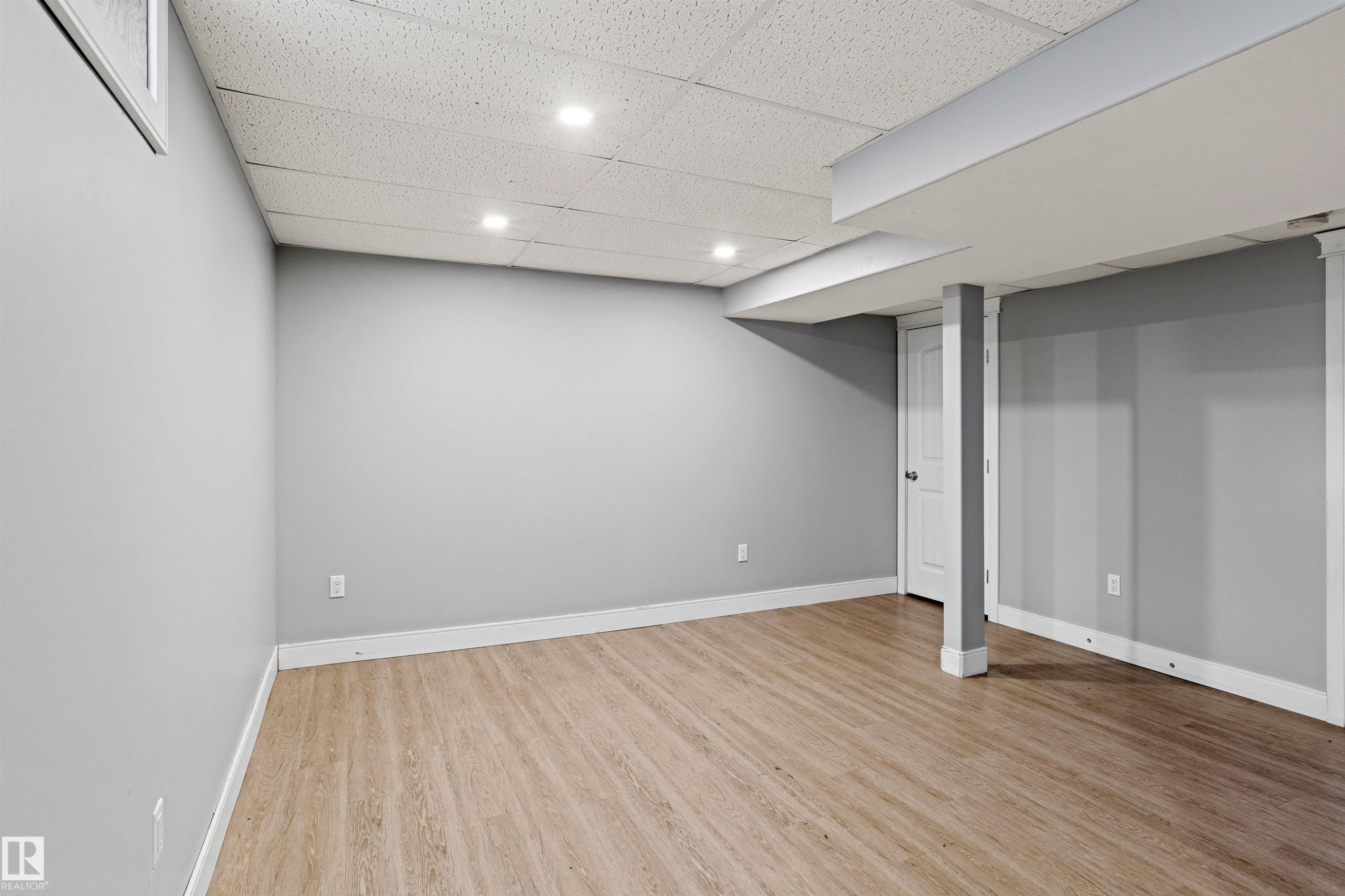Finished basement featuring a paneled ceiling, light wood-type flooring, and recessed lighting - 914 9 Street, Cold Lake, AB - Indoor