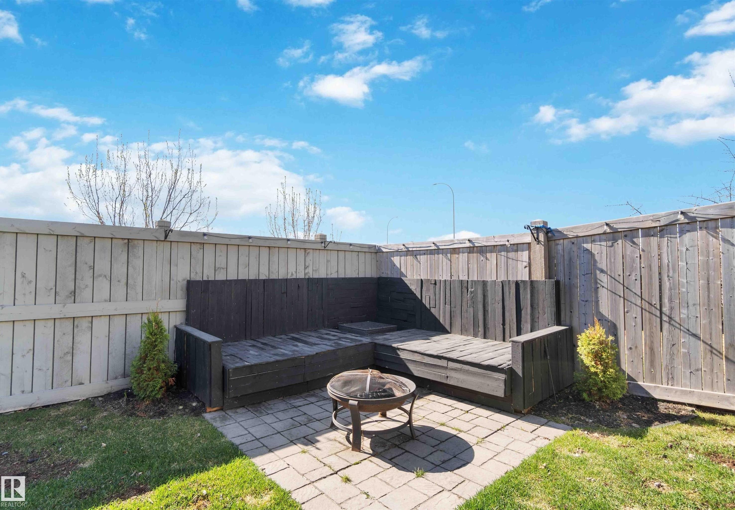Fenced backyard featuring a patio and a fire pit - 1965 118 Street, Edmonton, AB - Outdoor