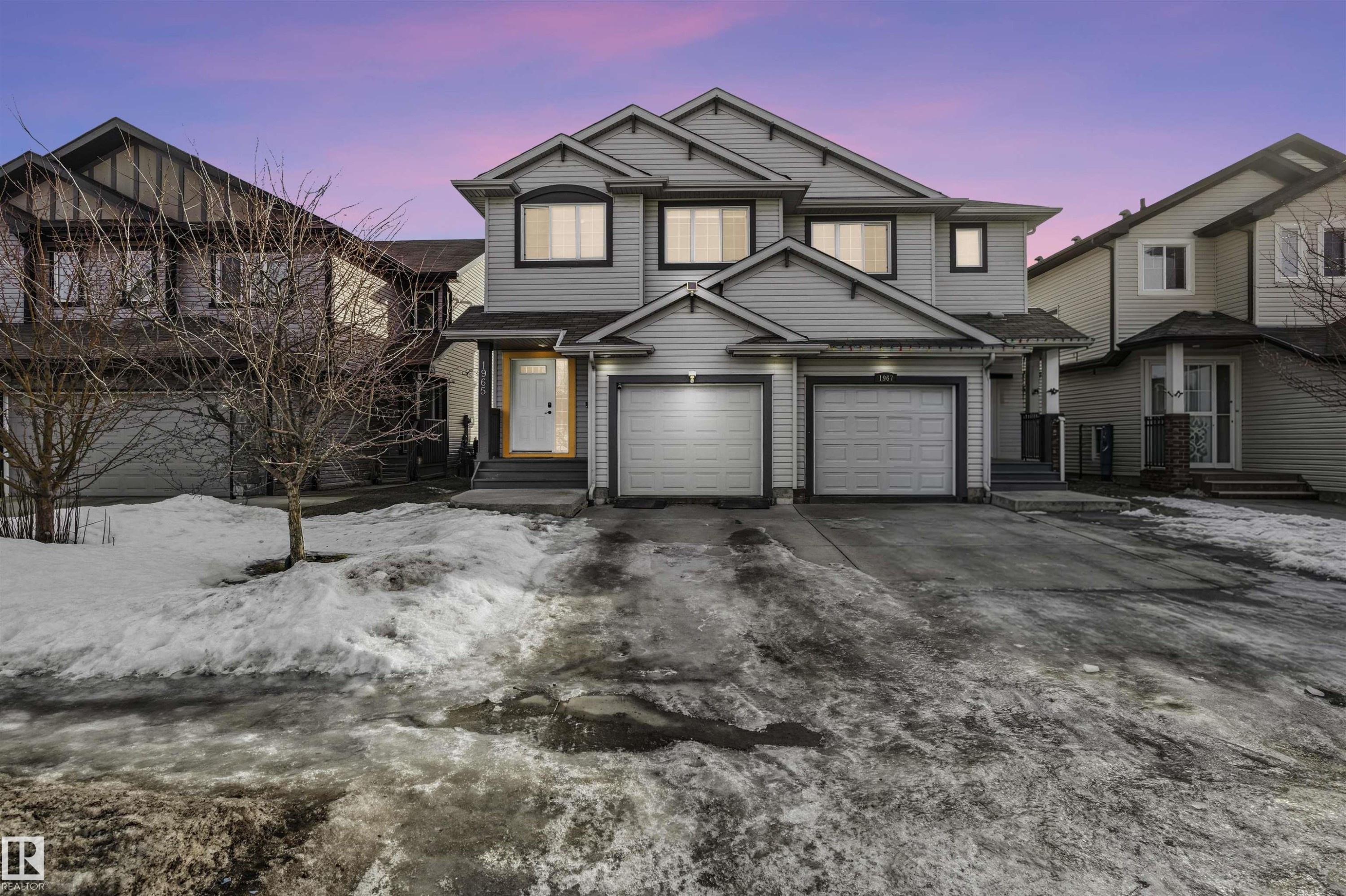 View of front of house featuring driveway, entry steps, and an attached garage - 1965 118 Street, Edmonton, AB - Outdoor With Facade