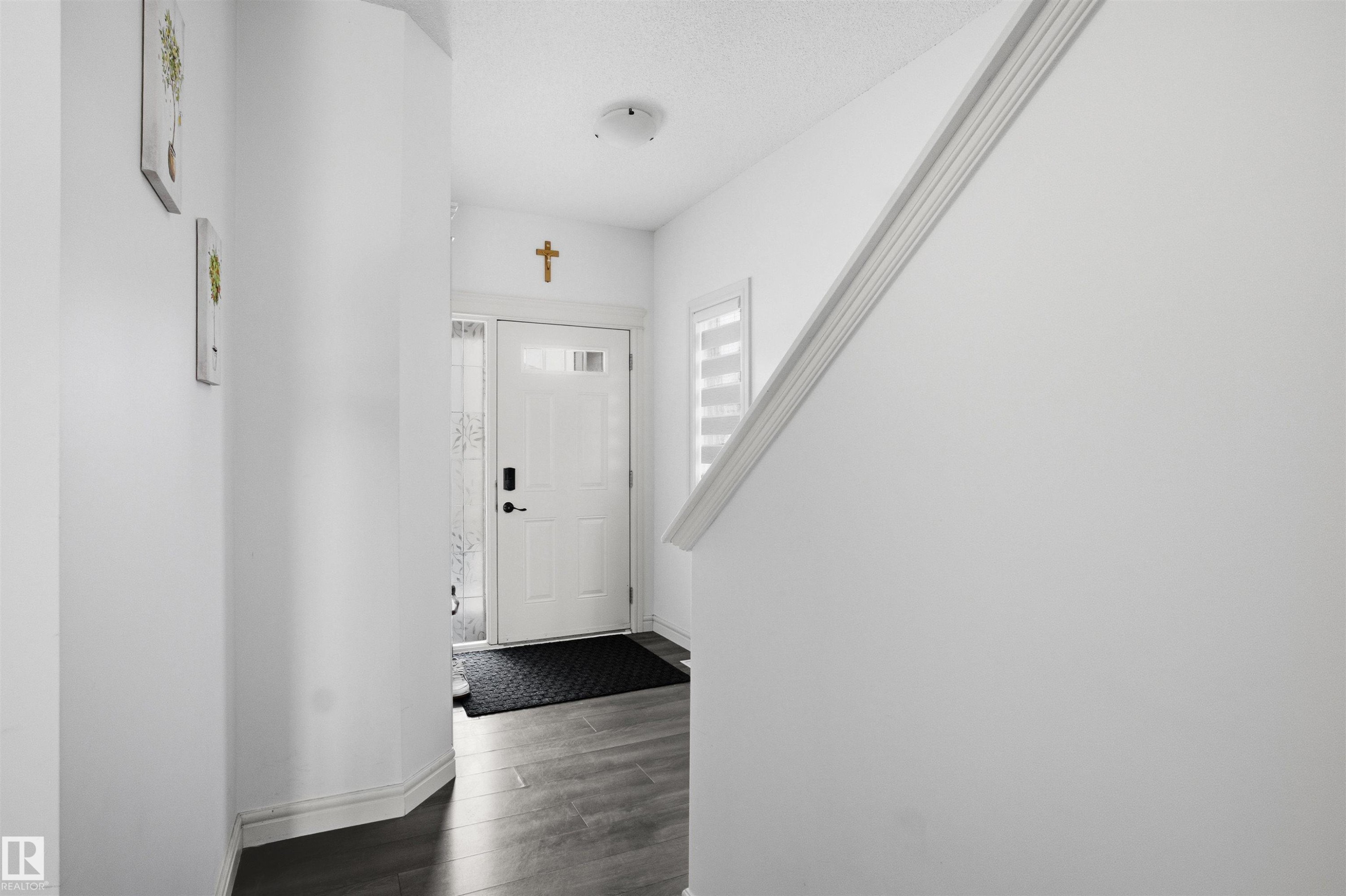Entryway featuring dark wood finished floors and a textured ceiling - 1965 118 Street, Edmonton, AB - Indoor Photo Showing Other Room