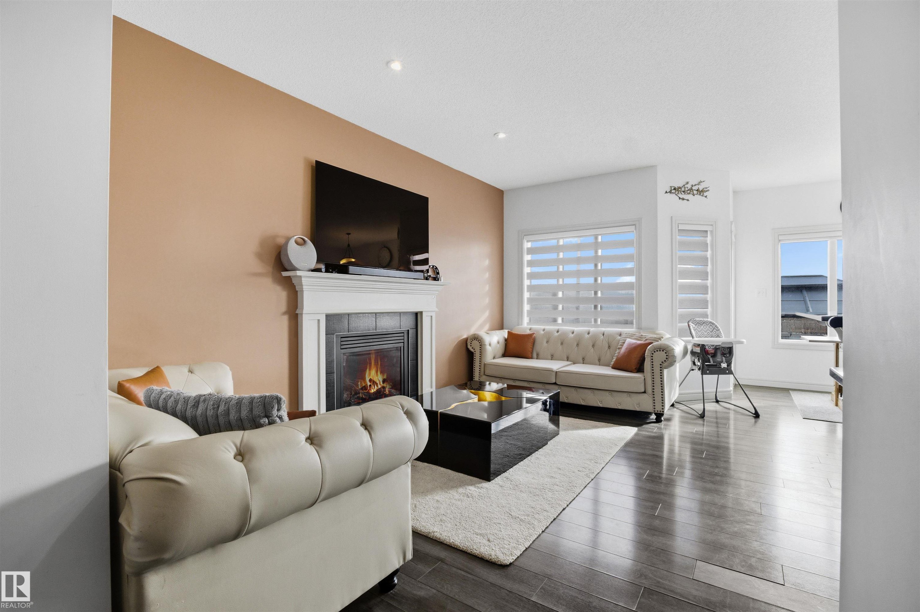 Living area with a fireplace, dark wood finished floors, and recessed lighting - 1965 118 Street, Edmonton, AB - Indoor Photo Showing Living Room With Fireplace