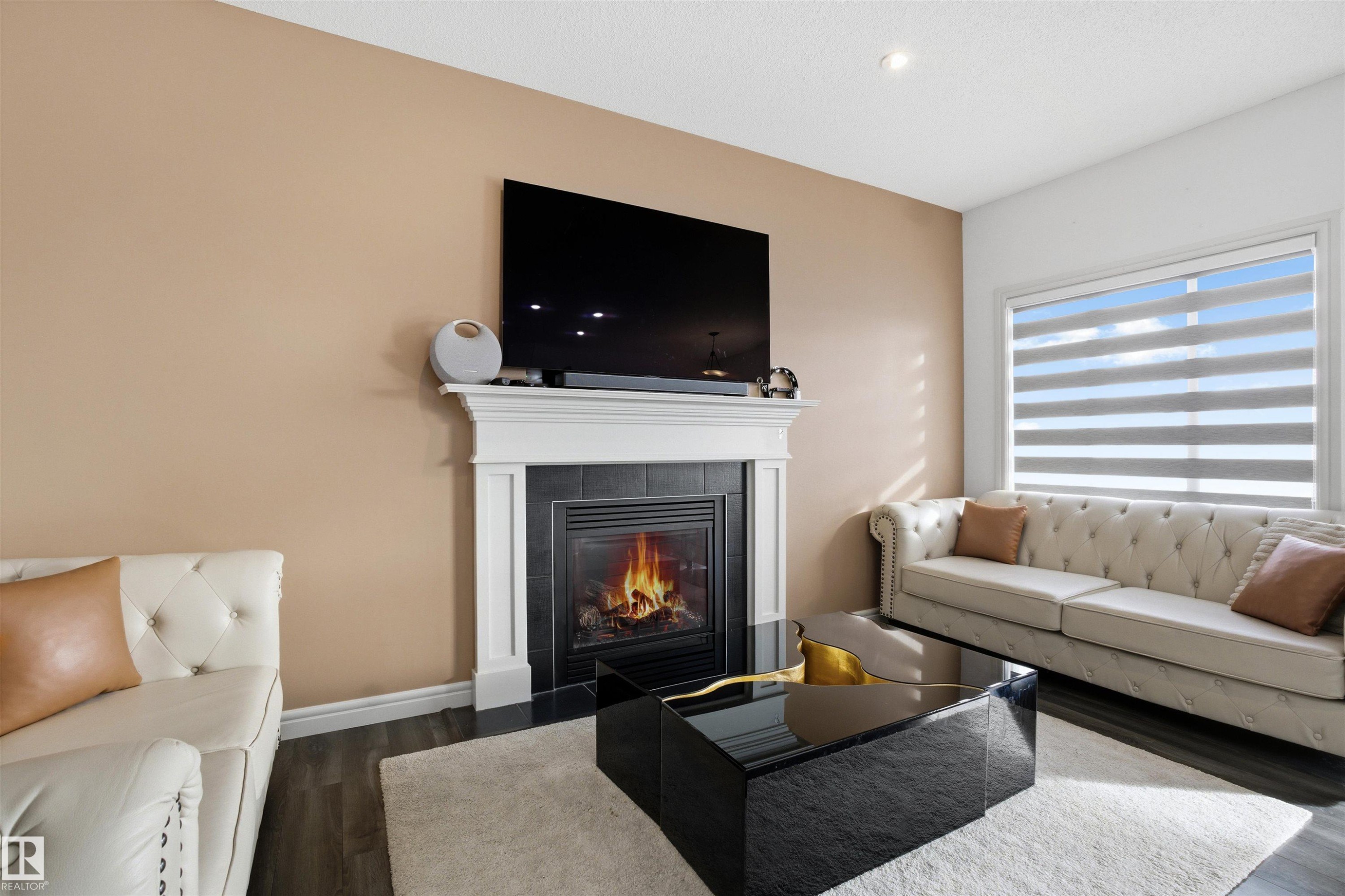 Living room with wood finished floors, a fireplace, and recessed lighting - 1965 118 Street, Edmonton, AB - Indoor Photo Showing Living Room With Fireplace