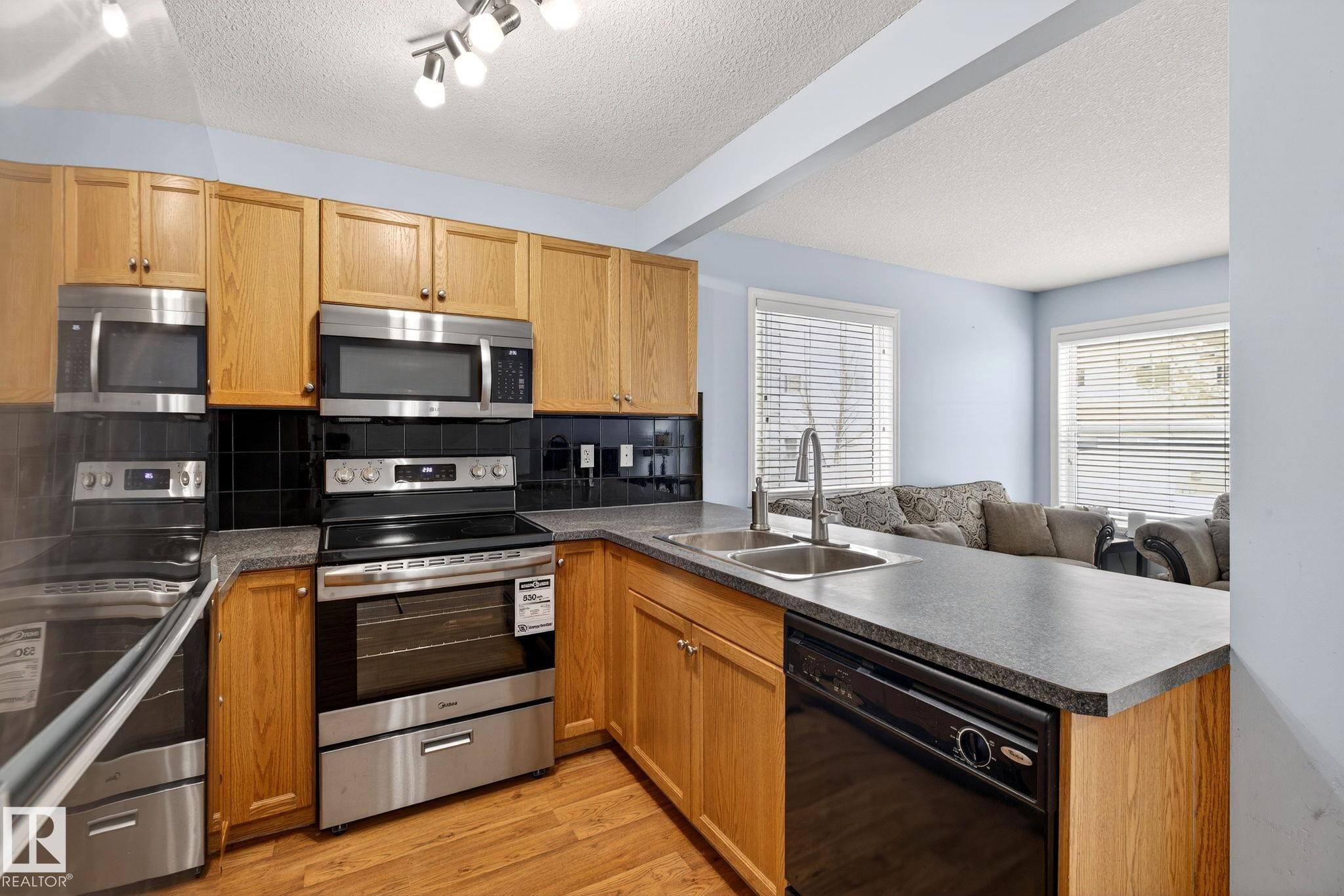 108 150 Edwards Drive, Edmonton, AB - Indoor Photo Showing Kitchen With Double Sink