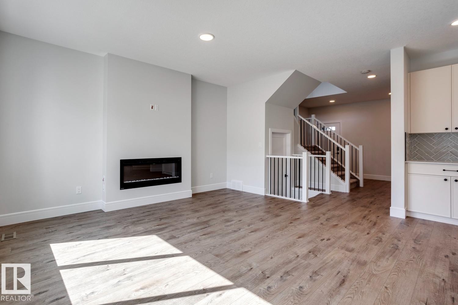 223 Ravine Drive, Devon, AB - Indoor Photo Showing Living Room With Fireplace