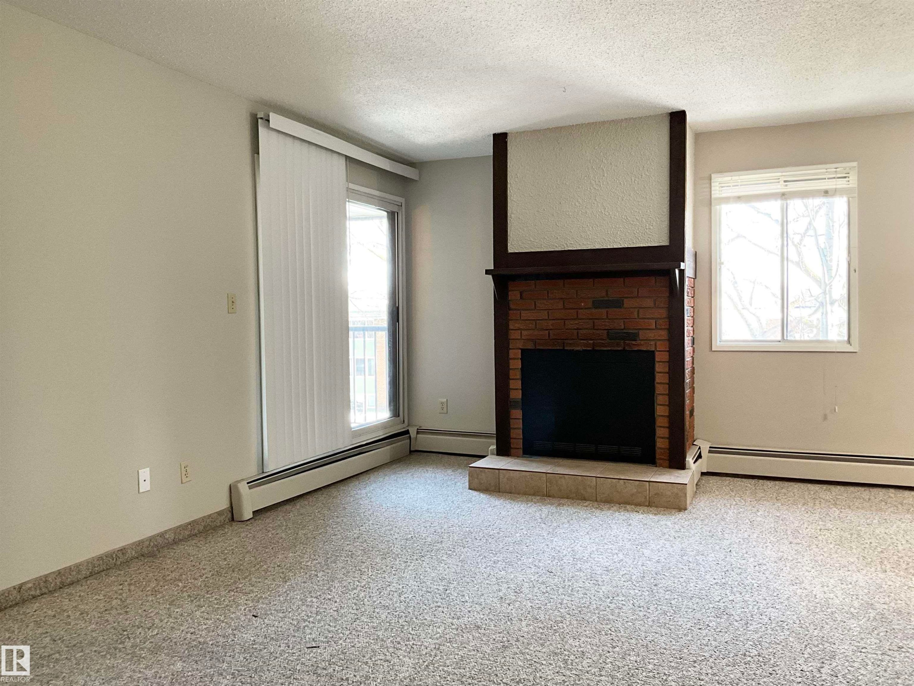 306 10826 113 Street, Edmonton, AB - Indoor Photo Showing Other Room With Fireplace