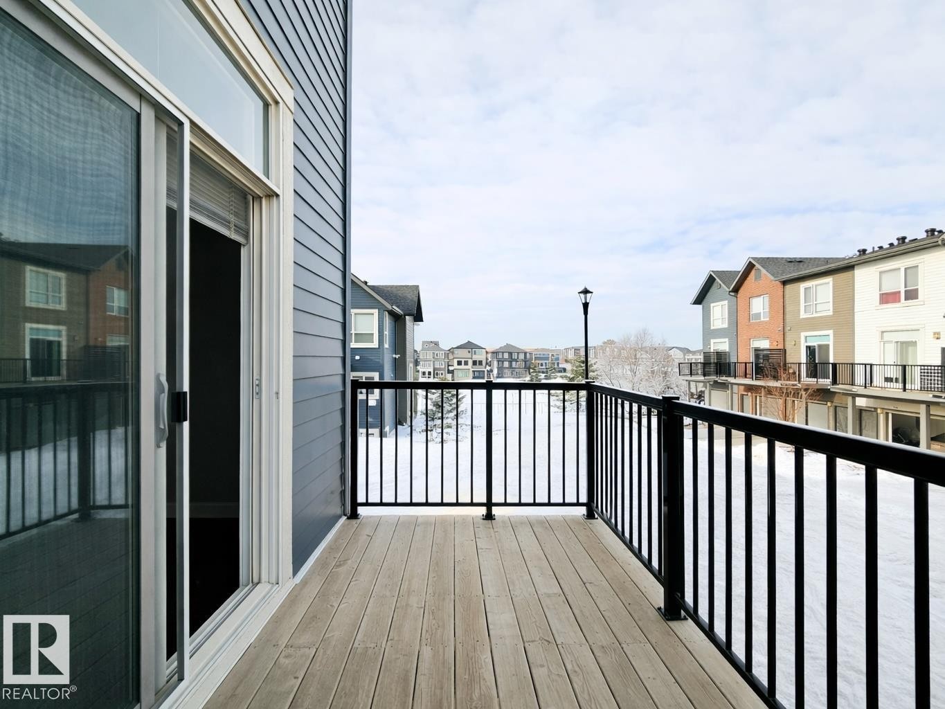 Wooden deck featuring a residential view - 129 2560 Pegasus Boulevard, Edmonton, AB - Outdoor With Balcony With Exterior