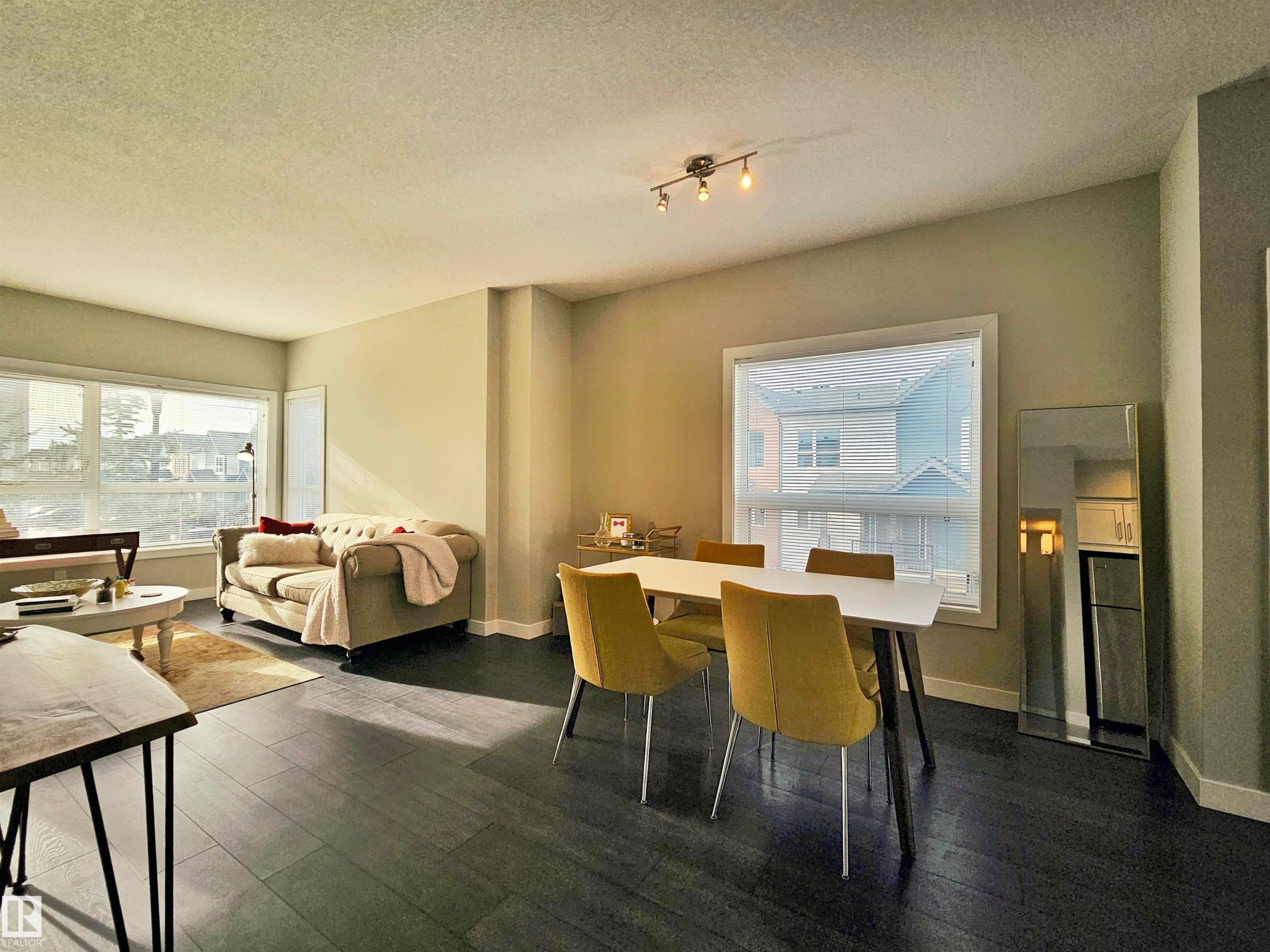 Dining space with a textured ceiling and dark wood-style floors - 129 2560 Pegasus Boulevard, Edmonton, AB - Indoor
