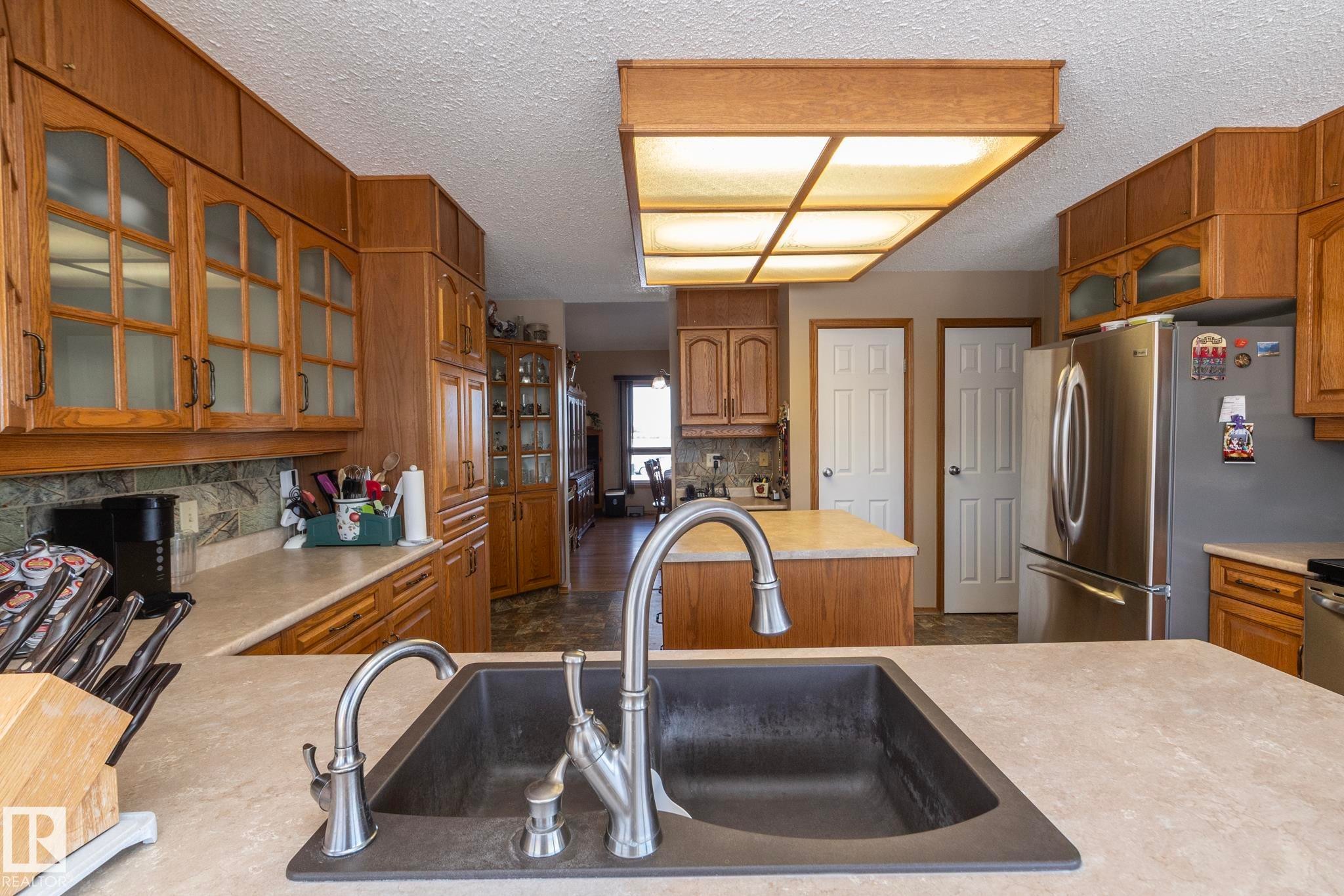 Located mere steps from the garage entryway, it's simple to bring in groceries and there's more than ample storage space to put EVERYTHING ! - 57524 Range Road 270, Rural Westlock County, AB - Indoor Photo Showing Kitchen With Double Sink