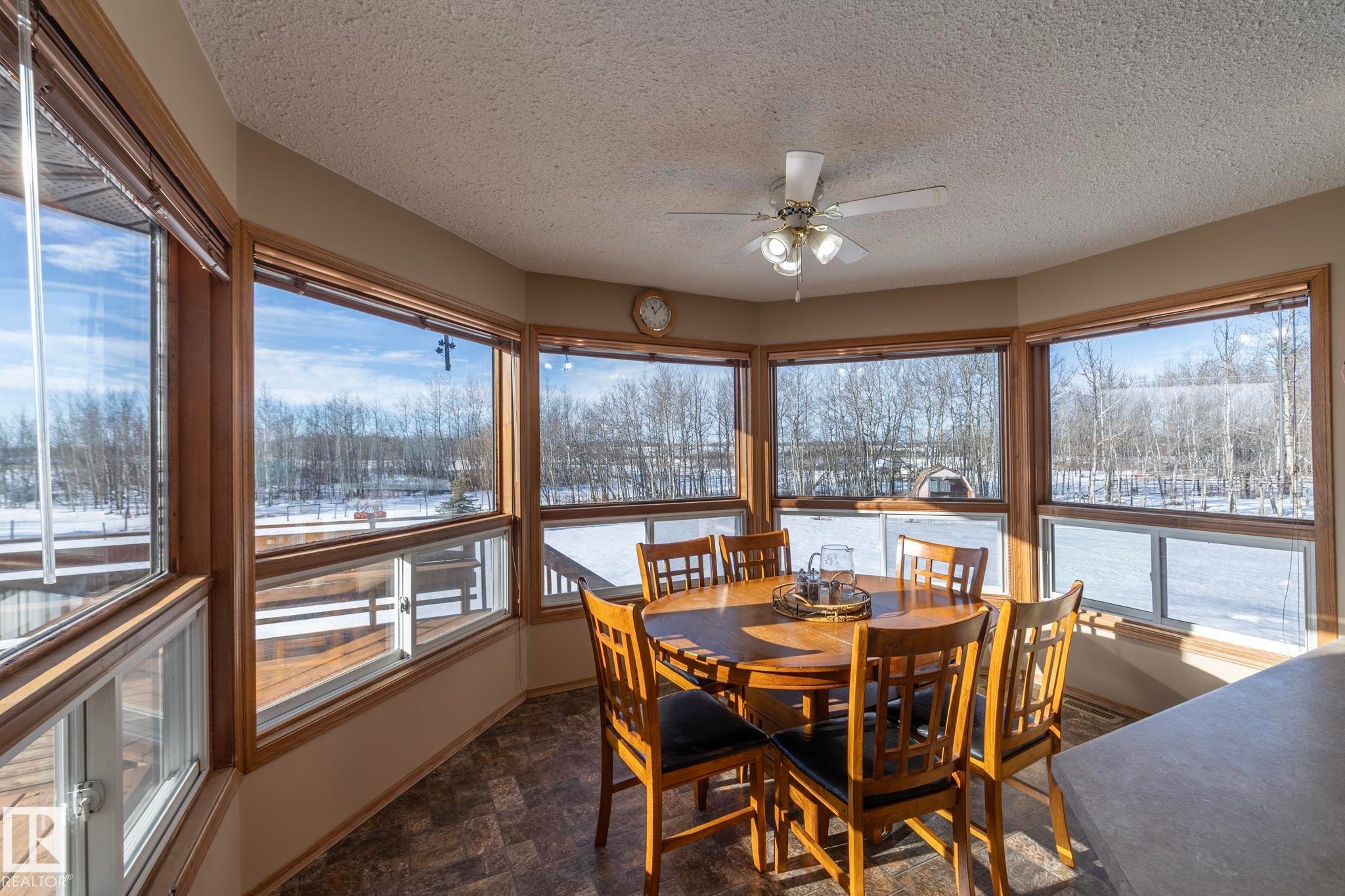 No matter what meal you're having, enjoy it HERE. Loads of natural light and plenty of elbow room. Great spot to bird watch, or maybe get a visit from wildlife....enjoy! - 57524 Range Road 270, Rural Westlock County, AB - Indoor Photo Showing Dining Room