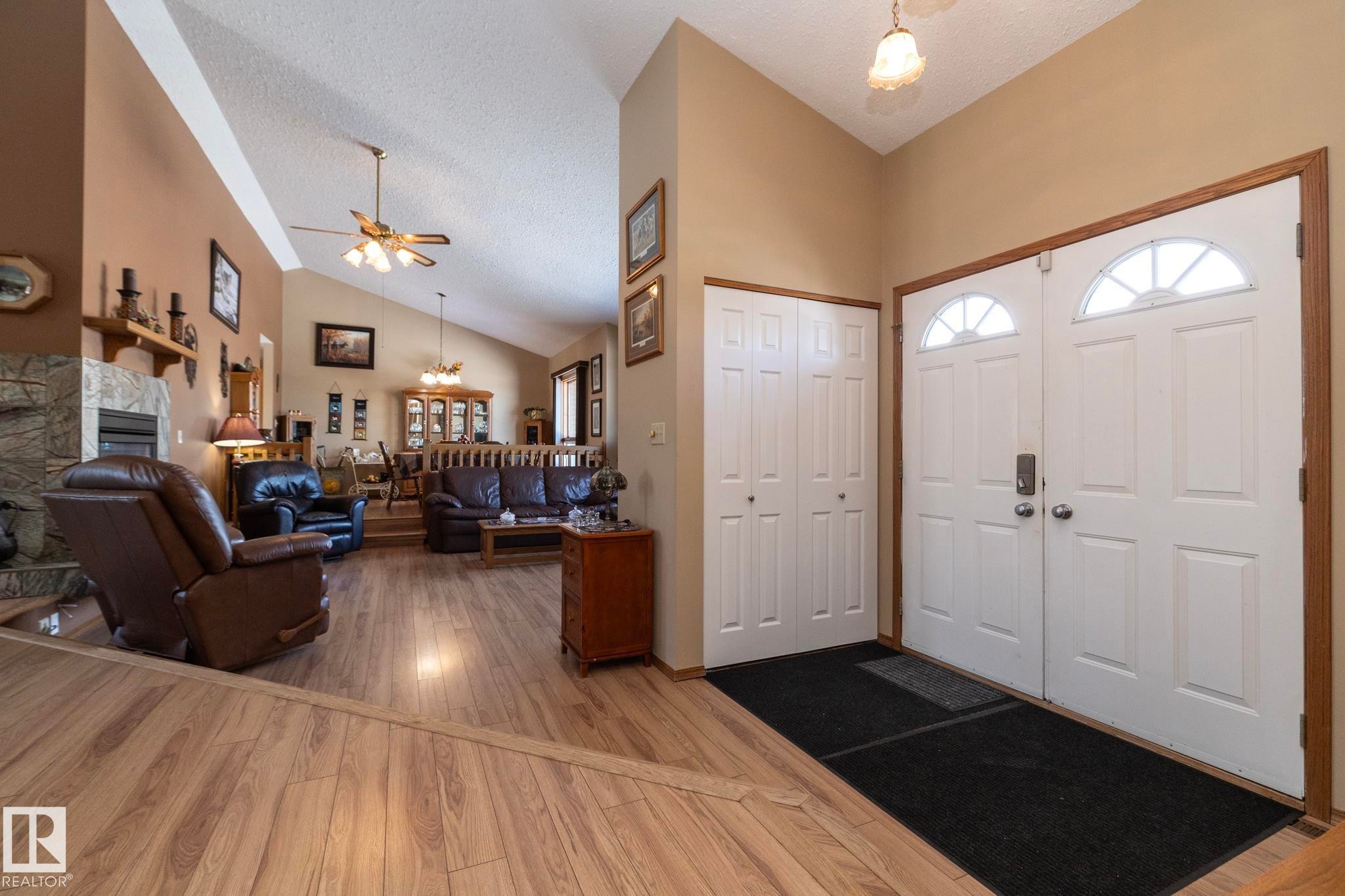 Large and welcoming to you and your guests. Ample space to get everyone in from the elements and get outerwear removed and put away.....Come on in!! - 57524 Range Road 270, Rural Westlock County, AB - Indoor With Fireplace