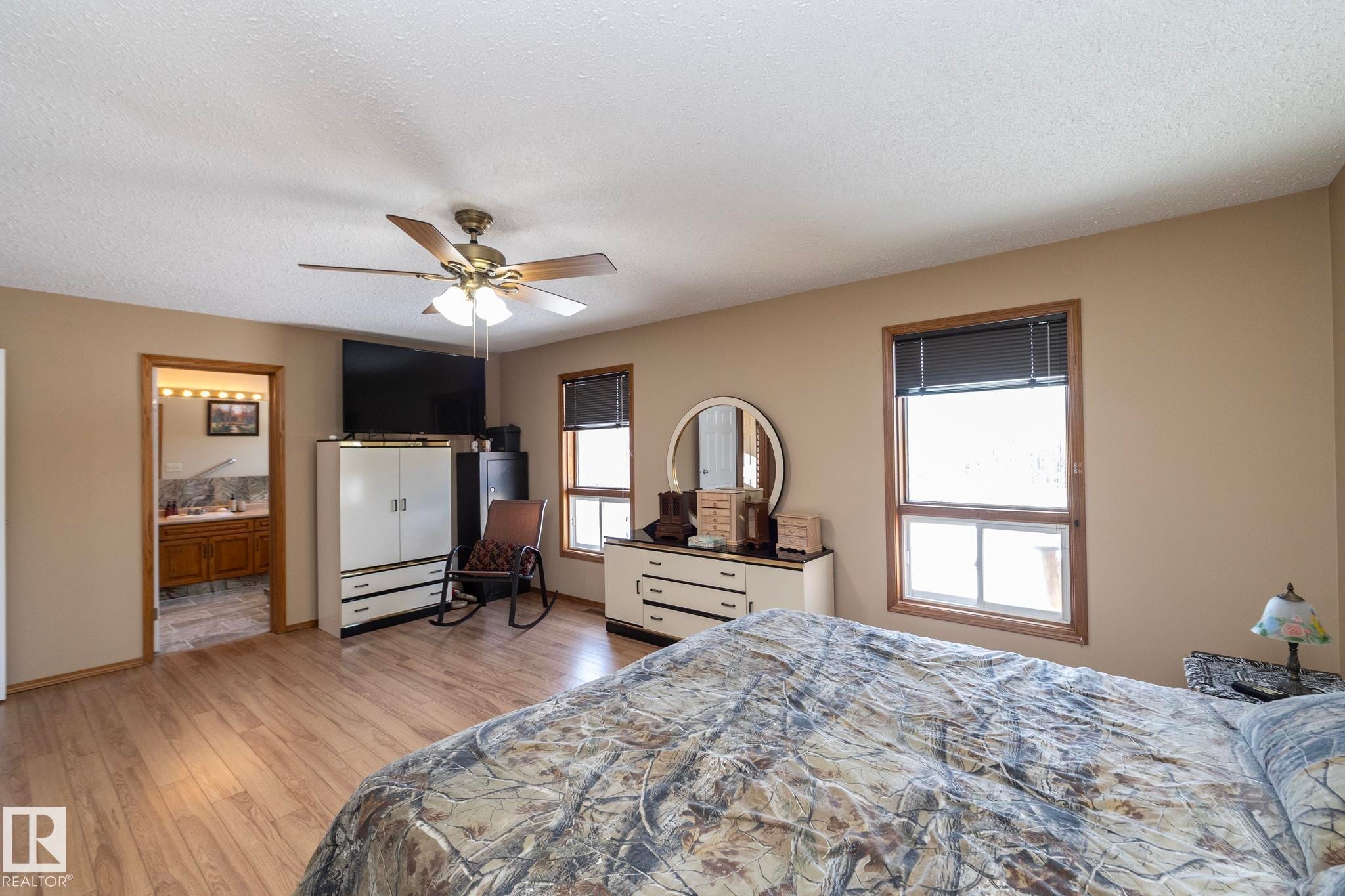 Plenty of natural light comes through the large windows. West facing, so sunsets can lead to star gazing. - 57524 Range Road 270, Rural Westlock County, AB - Indoor Photo Showing Bedroom