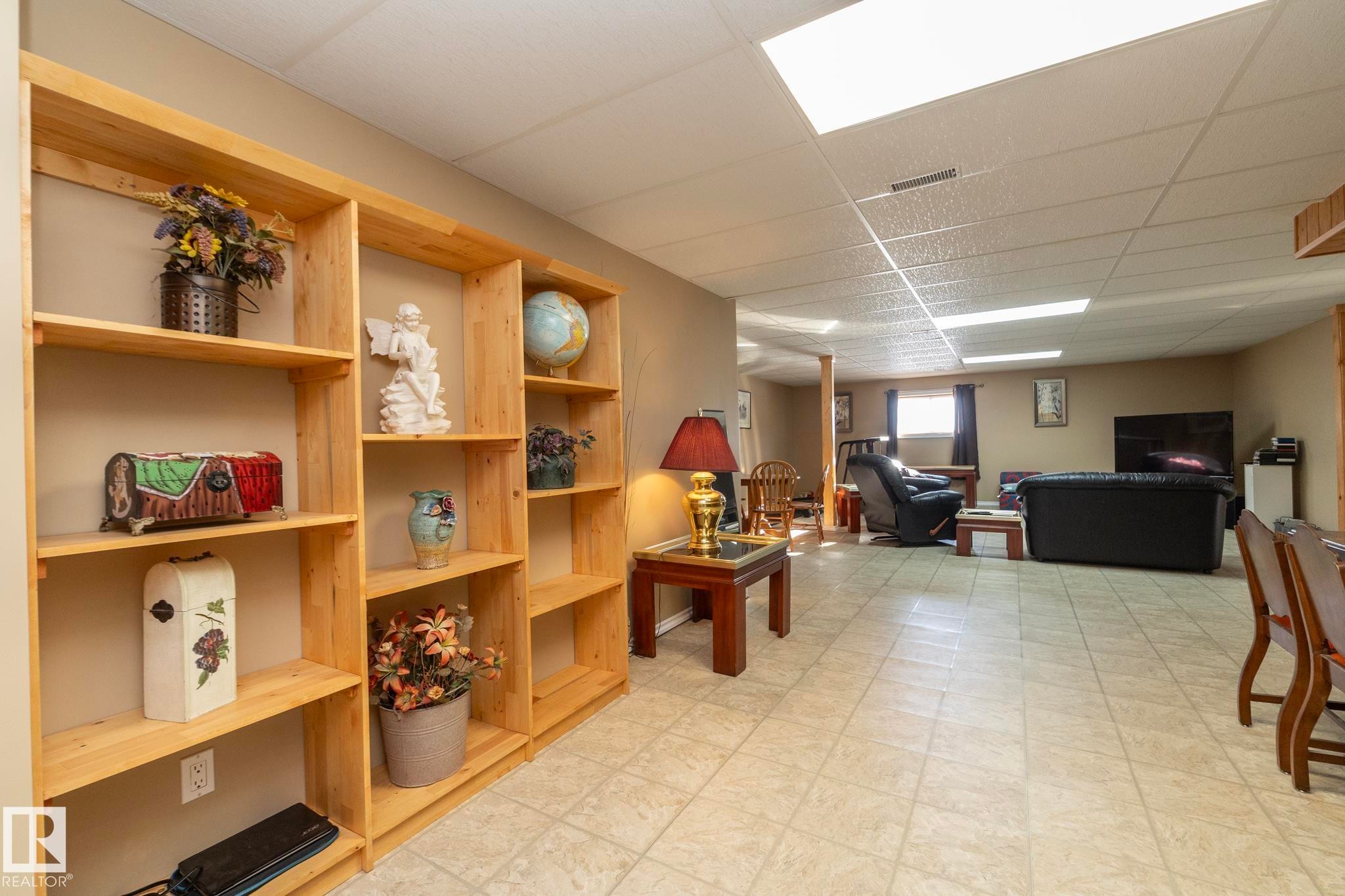 Just a few steps from the kitchen/eating area, this hallway invites & leads to more space to enjoy... Shelves for games, books, etc....the family room awaits... - 57524 Range Road 270, Rural Westlock County, AB - Indoor