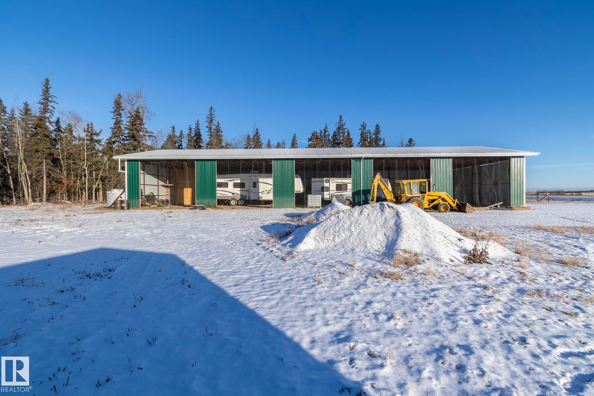 Long storage shed Built hay-shed style, this long shed is great for "toys" of most sizes. Barn style doors toward roadway. Open but meshed to keep animals/birds out. Approximately 130 ft long, 28 ft wide. Metal. - 57524 Range Road 270, Rural Westlock County, AB - Outdoor