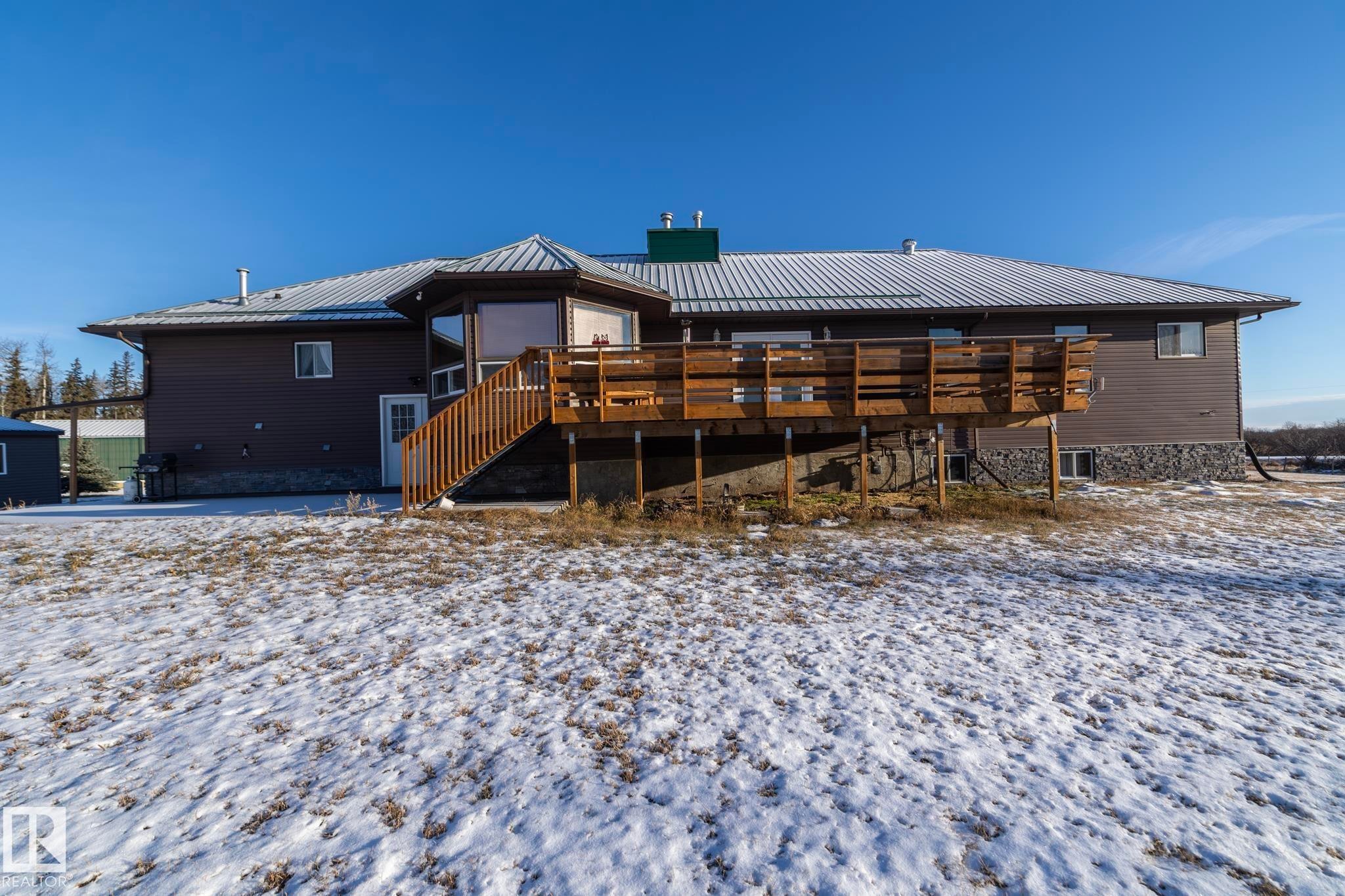 View of the back of the house from the yard. Space inside and outside. LOADS of space for playing outside - 57524 Range Road 270, Rural Westlock County, AB - Outdoor With Deck Patio Veranda