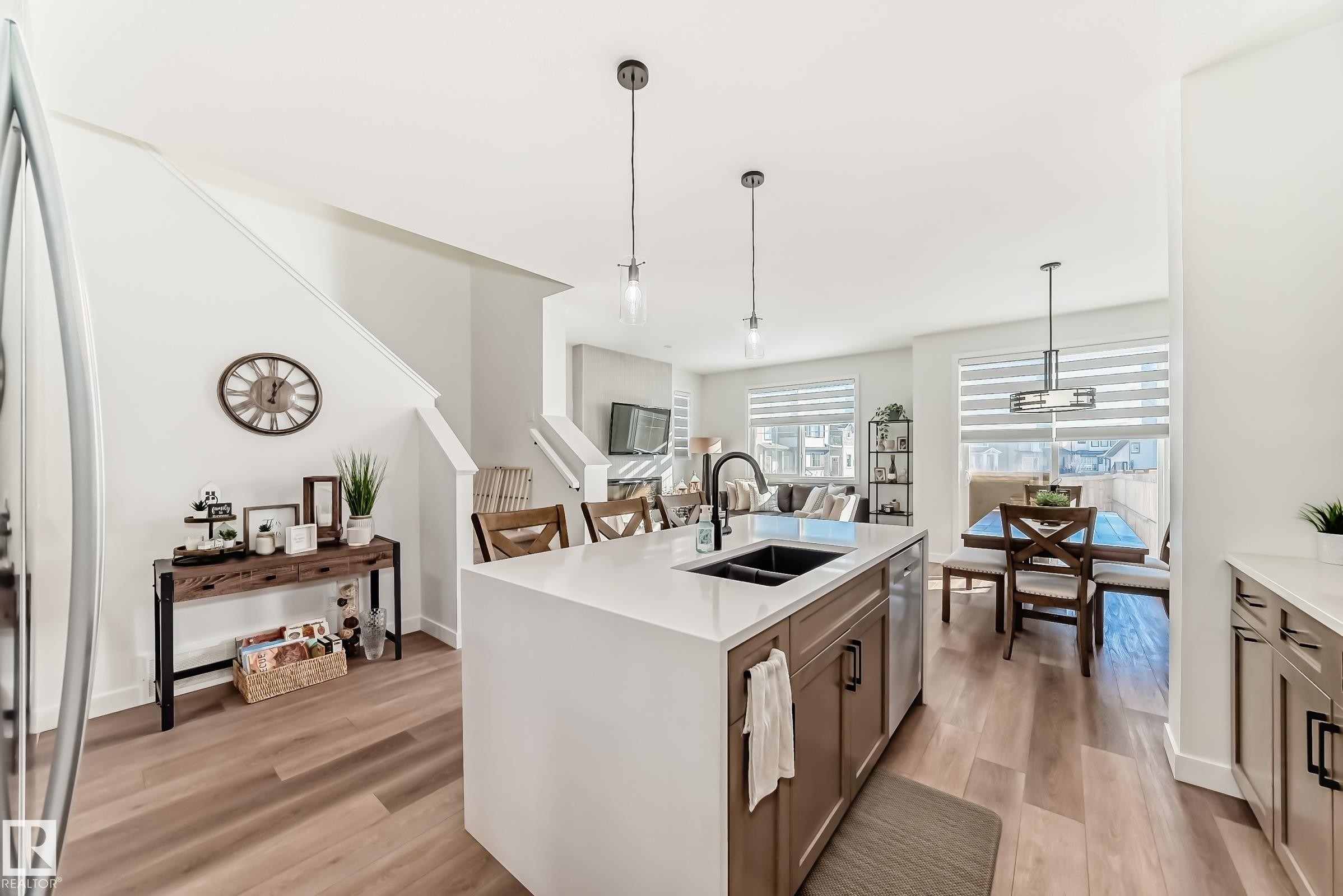 Kitchen with pendant lighting, light wood-style floors, a kitchen island with sink, and light stone countertops - 3569 Erlanger Link, Edmonton, AB - Indoor Photo Showing Kitchen With Double Sink With Upgraded Kitchen