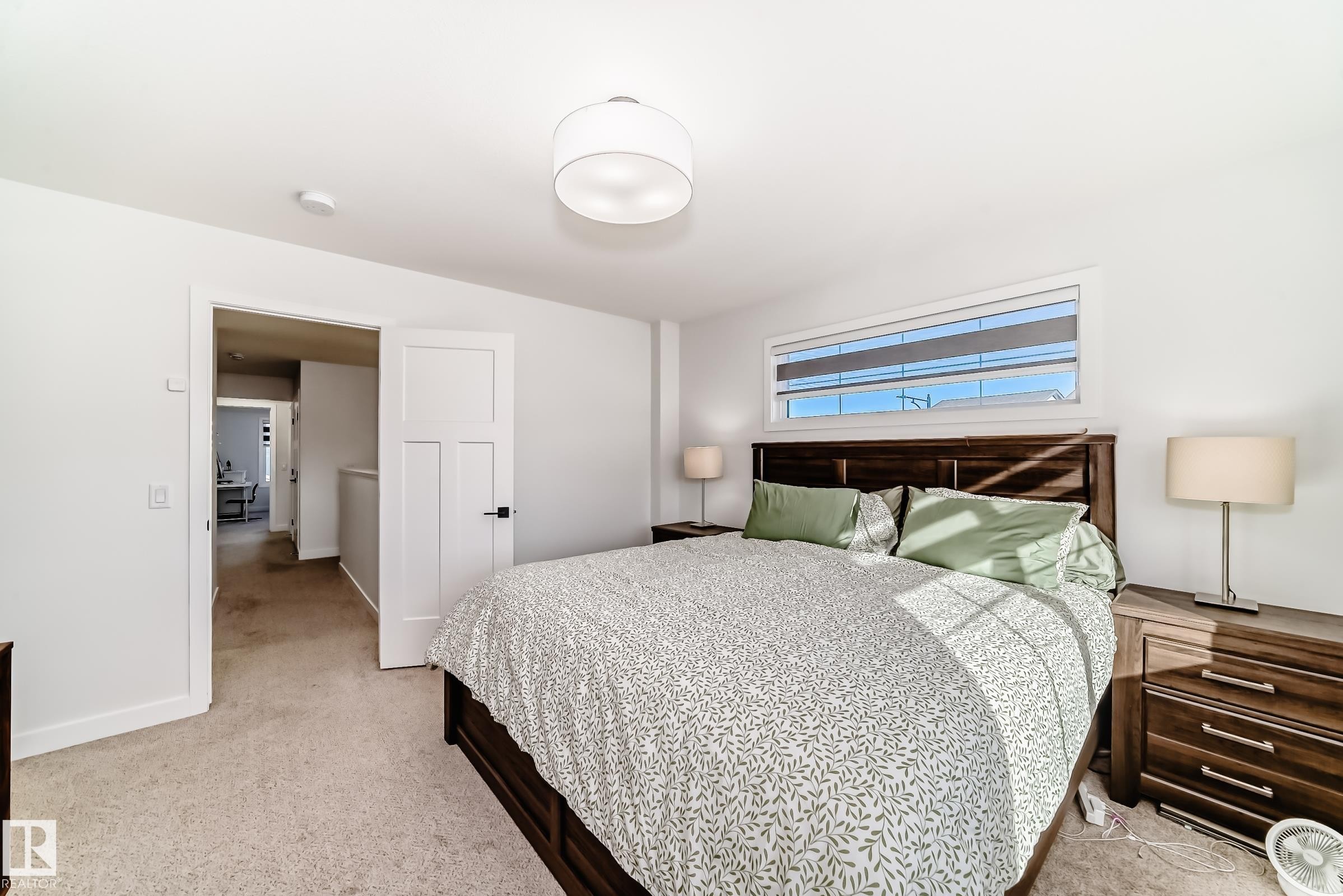 Bedroom with light carpet and baseboards - 3569 Erlanger Link, Edmonton, AB - Indoor Photo Showing Bedroom