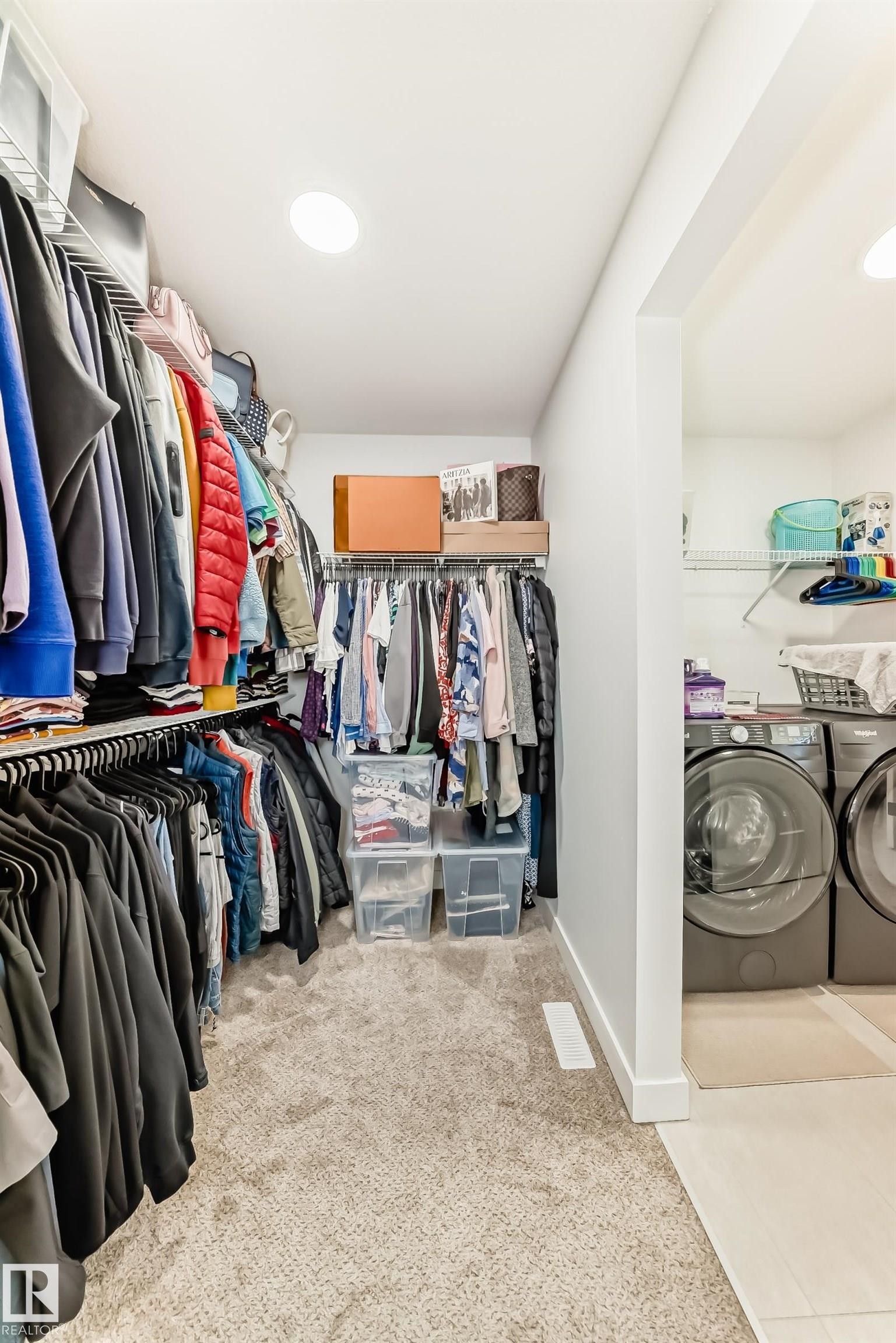 Walk in closet with separate washer and dryer and light colored carpet - 3569 Erlanger Link, Edmonton, AB - Indoor With Storage
