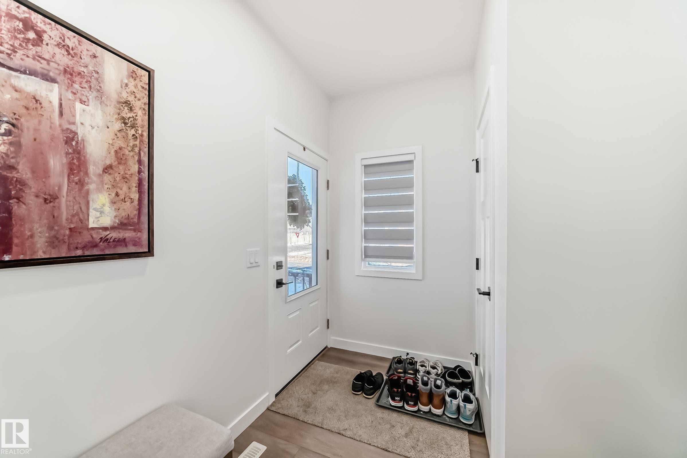Doorway to outside featuring wood finished floors and baseboards - 3569 Erlanger Link, Edmonton, AB - Indoor Photo Showing Other Room