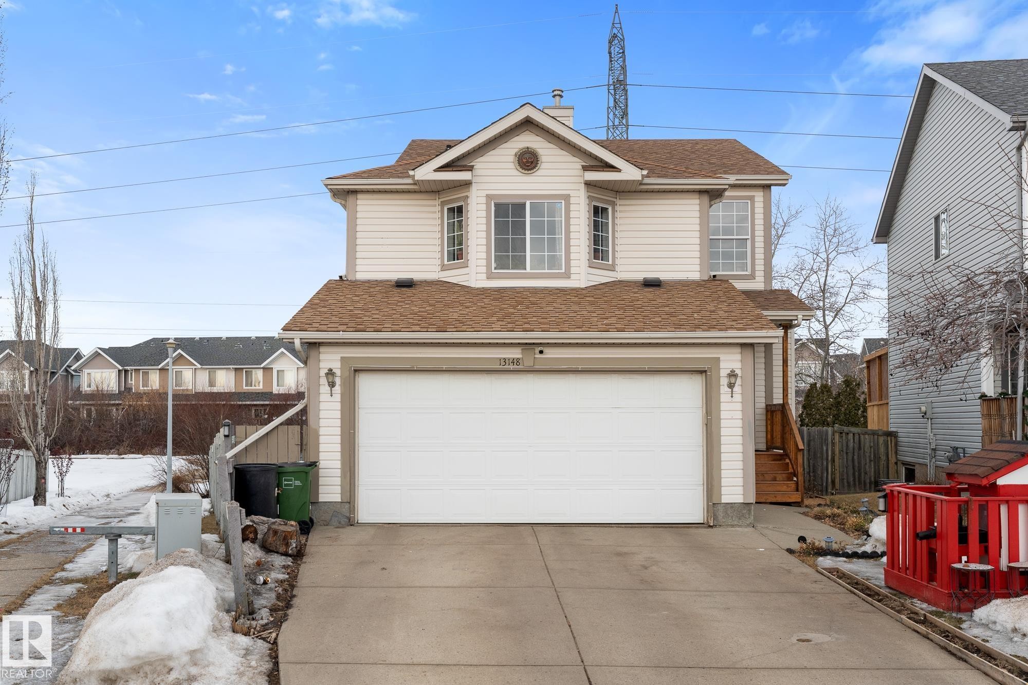 Traditional-style house with a shingled roof, an attached garage, and concrete driveway - 13148 151 Avenue, Edmonton, AB - Outdoor