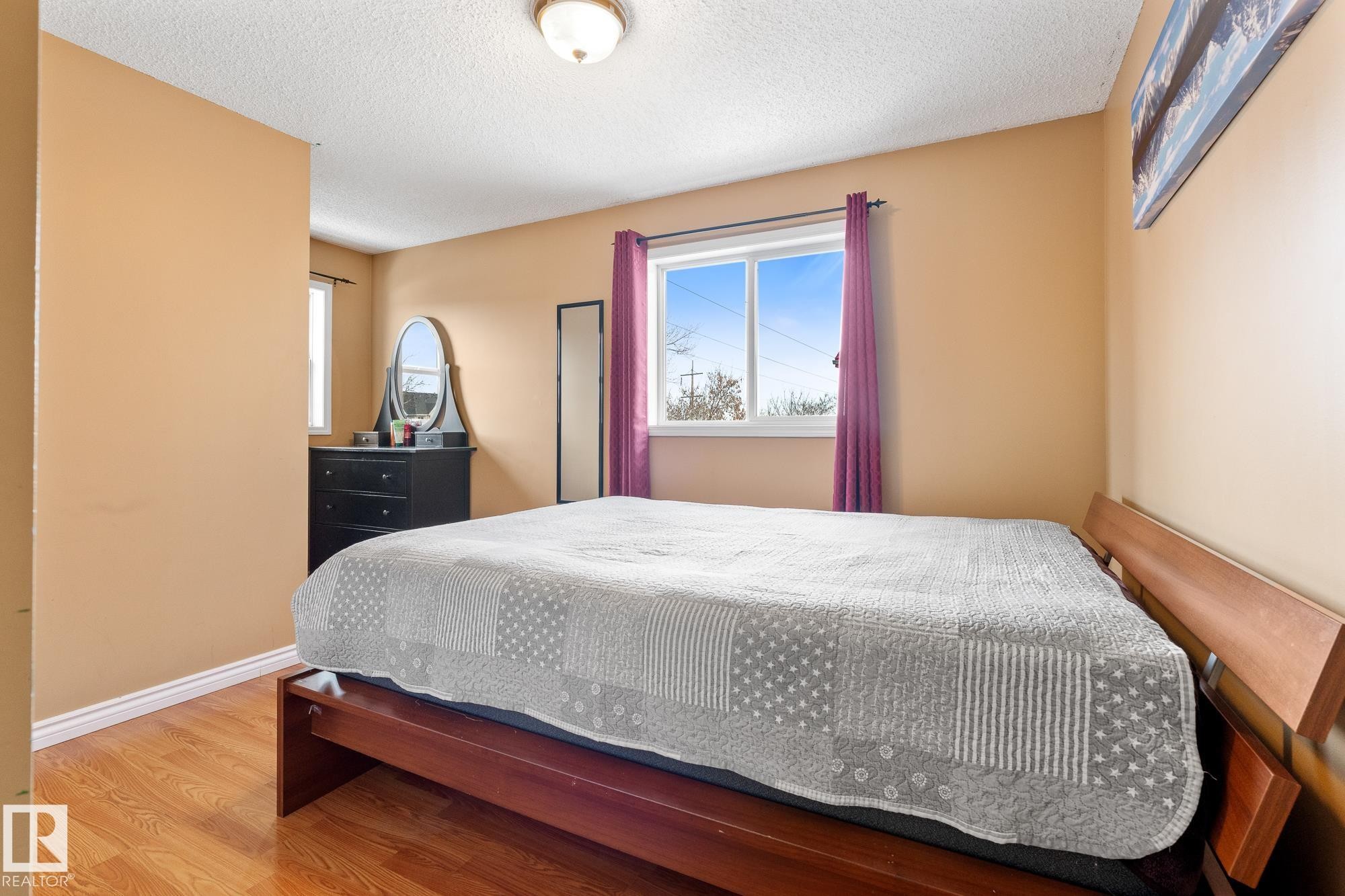 Bedroom with wood finished floors and a textured ceiling - 13148 151 Avenue, Edmonton, AB - Indoor Photo Showing Bedroom