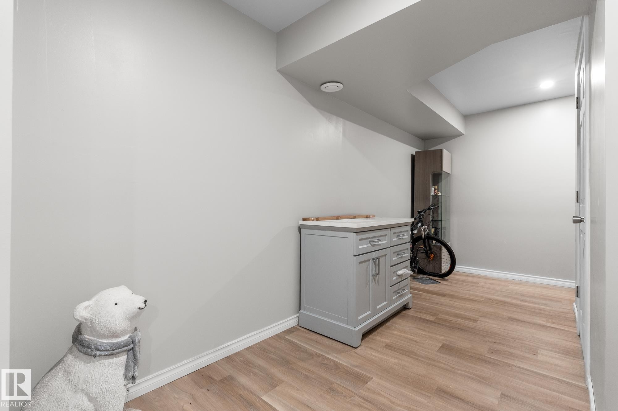 Interior space with gray cabinets, light wood finished floors, and light countertops - 13148 151 Avenue, Edmonton, AB - Indoor Photo Showing Other Room
