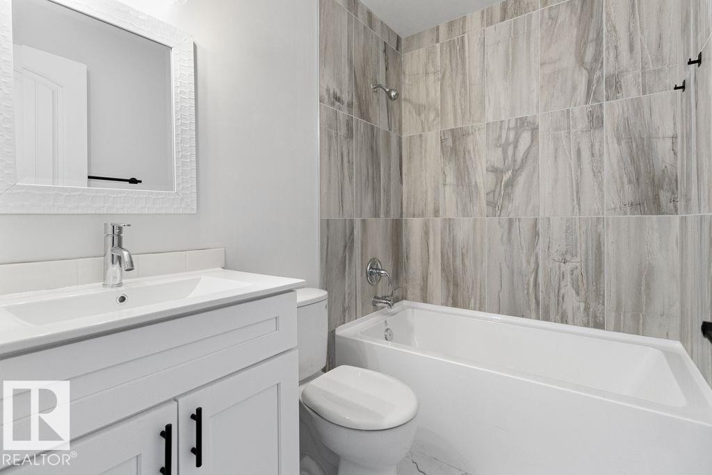 Full bathroom featuring vanity and washtub / shower combination - 875 Juniper Avenue, Sherwood Park, AB - Indoor Photo Showing Bathroom