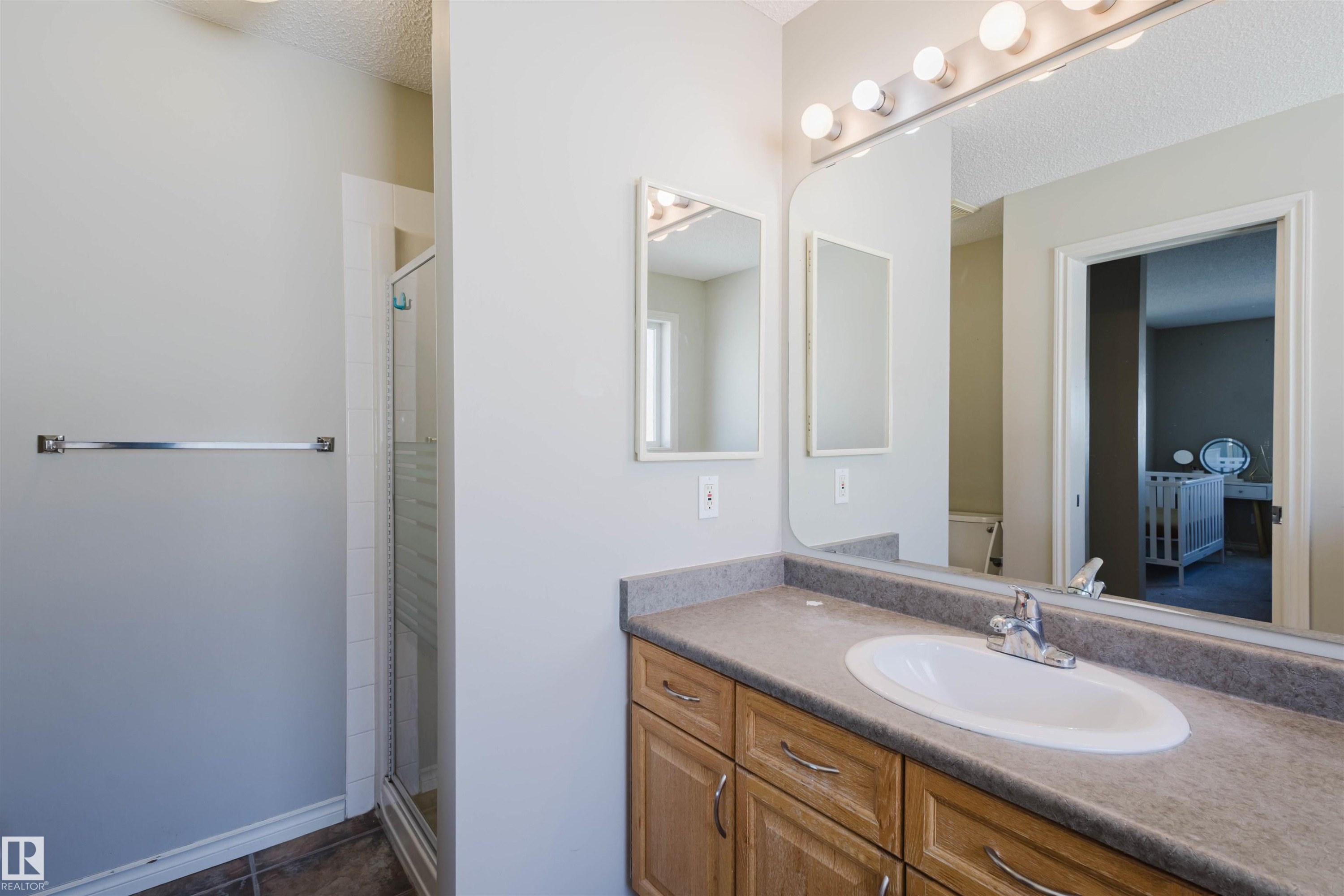 Bathroom featuring a stall shower, vanity, and a textured ceiling - 3534 Mclean Crescent, Edmonton, AB - Indoor Photo Showing Bathroom