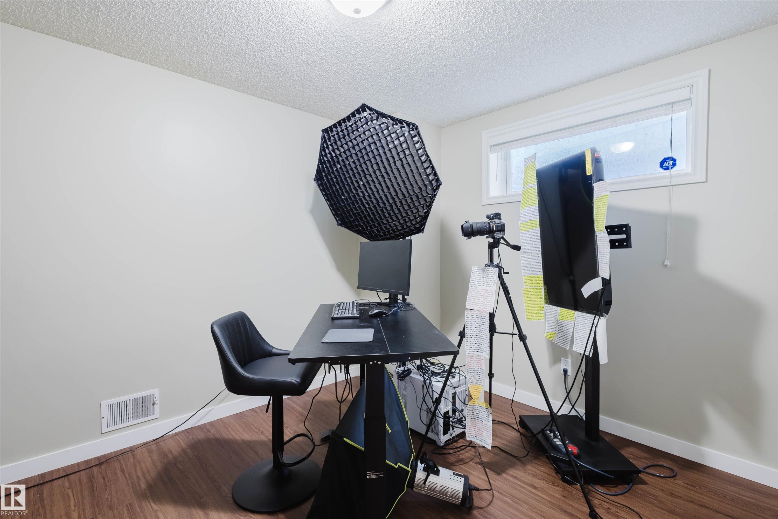Workout area featuring a textured ceiling and wood finished floors - 3534 Mclean Crescent, Edmonton, AB - Indoor