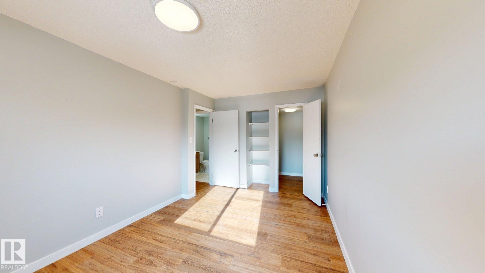 Unfurnished bedroom with light wood-style floors and baseboards - 611 2908 116A Avenue, Edmonton, AB - Indoor Photo Showing Other Room