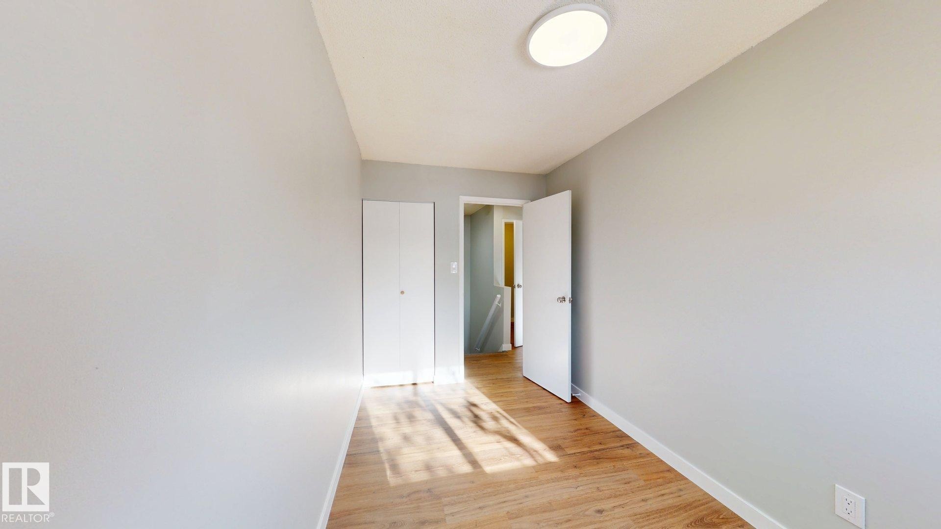 Unfurnished bedroom with light wood-style floors and baseboards - 611 2908 116A Avenue, Edmonton, AB - Indoor Photo Showing Other Room